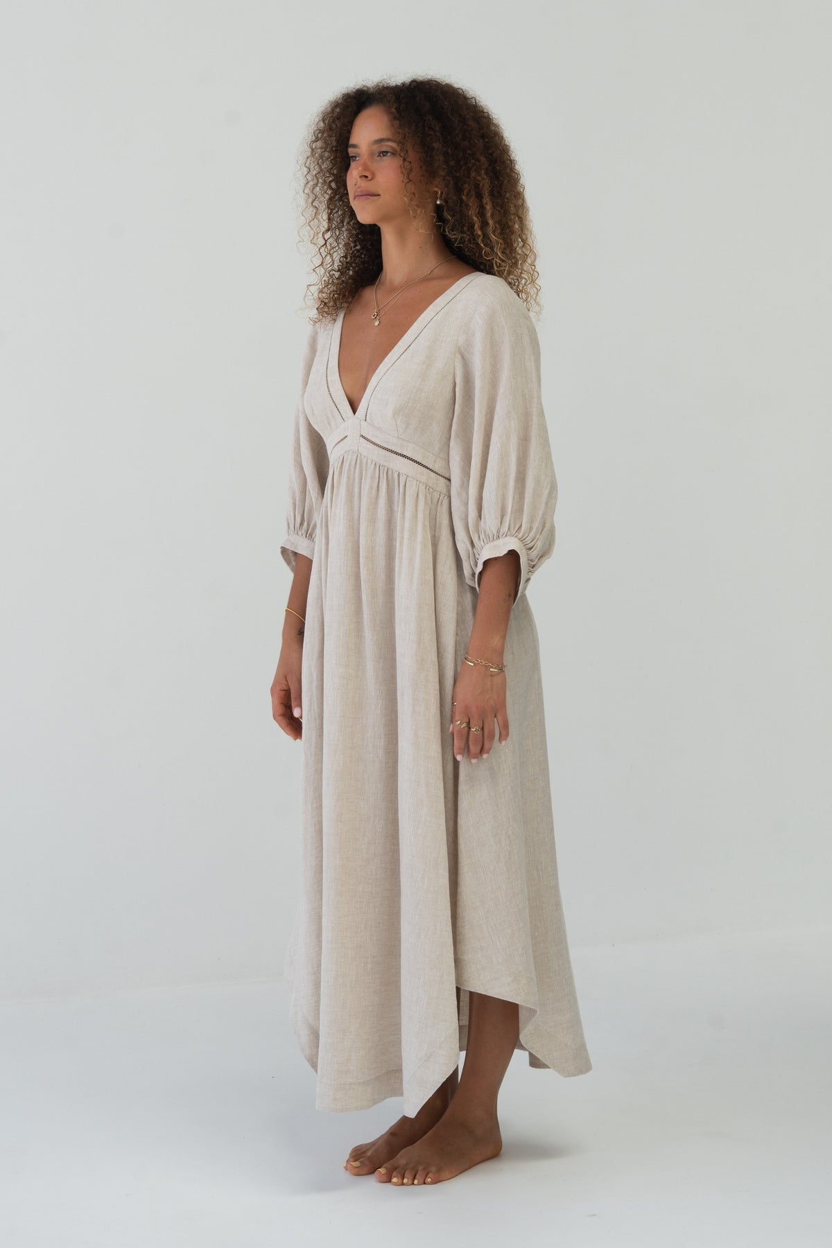 Josie Linen Midi Dress in Oatmeal - side view showing flowy skirt and bell sleeves - Lilly Pilly Collection