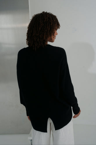 June Cashmere Knit in Black - back view, styled with Rika Linen Pants in Ivory, plain background - Lilly Pilly Collection