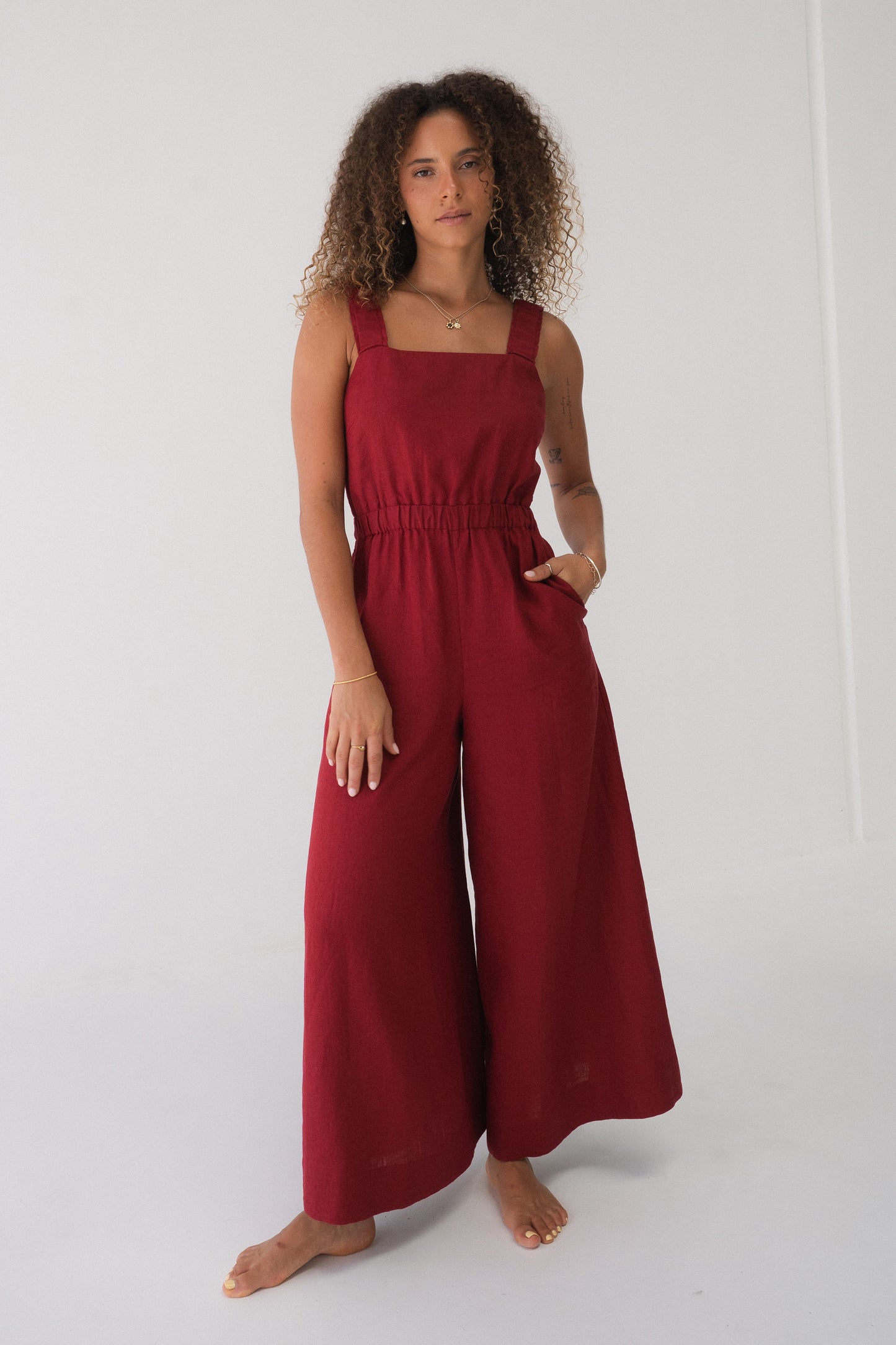 Front view of a woman wearing the Keely Linen jumpsuit in Cherry Red - Lilly Pilly Collection