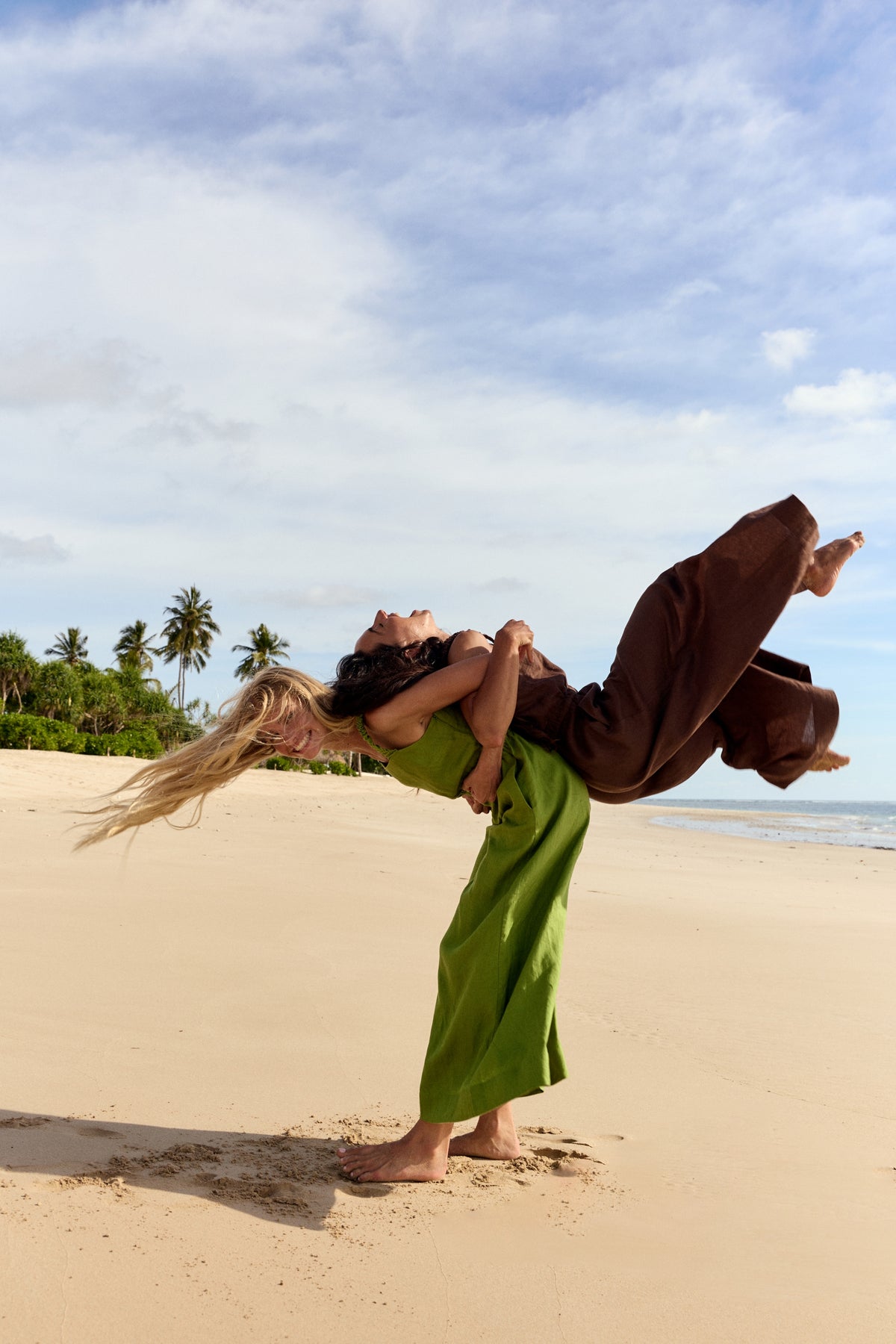 Two women playing while wearing the Keely Linen jumpsuit in Chocolate and Lime Green - Lilly Pilly Collection