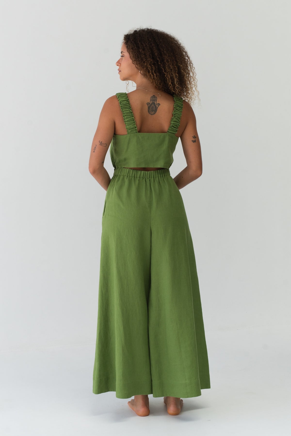 Back view of a woman wearing the Keely Linen jumpsuit in Lime Green - Lilly Pilly Collection