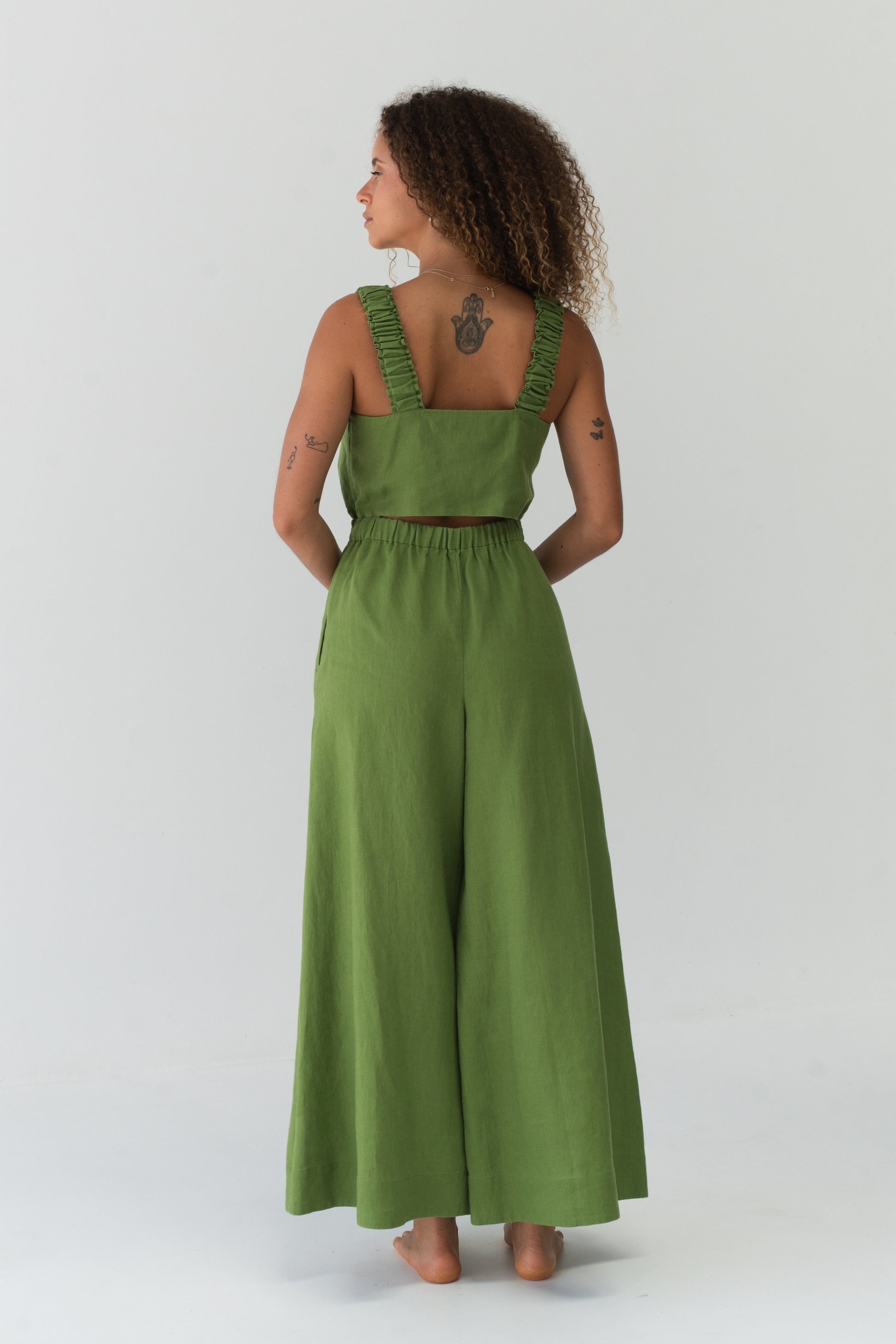 Back view of a woman wearing the Keely Linen jumpsuit in Lime Green - Lilly Pilly Collection