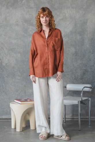 Kirra Linen Shirt in Cajun Red - full length front view, worn with Oli Linen Pants in Oatmeal, studio setting - Lilly Pilly Collection