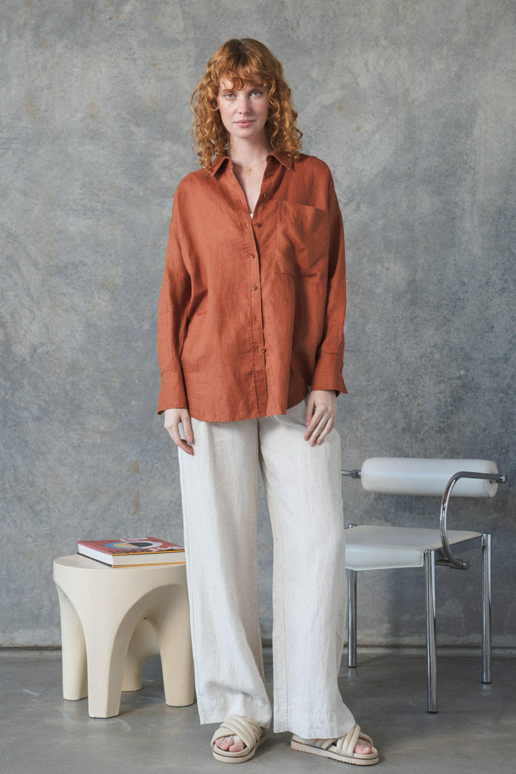 Kirra Linen Shirt in Cajun Red - full length front view, worn with wide-leg trousers, studio setting - Lilly Pilly Collection