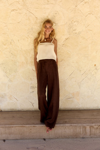 Leni Silk Cami in Ivory - full length, square neckline and thin straps, worn with Oli Pants in Chocolate, textured wall backdrop - Lilly Pilly Collection