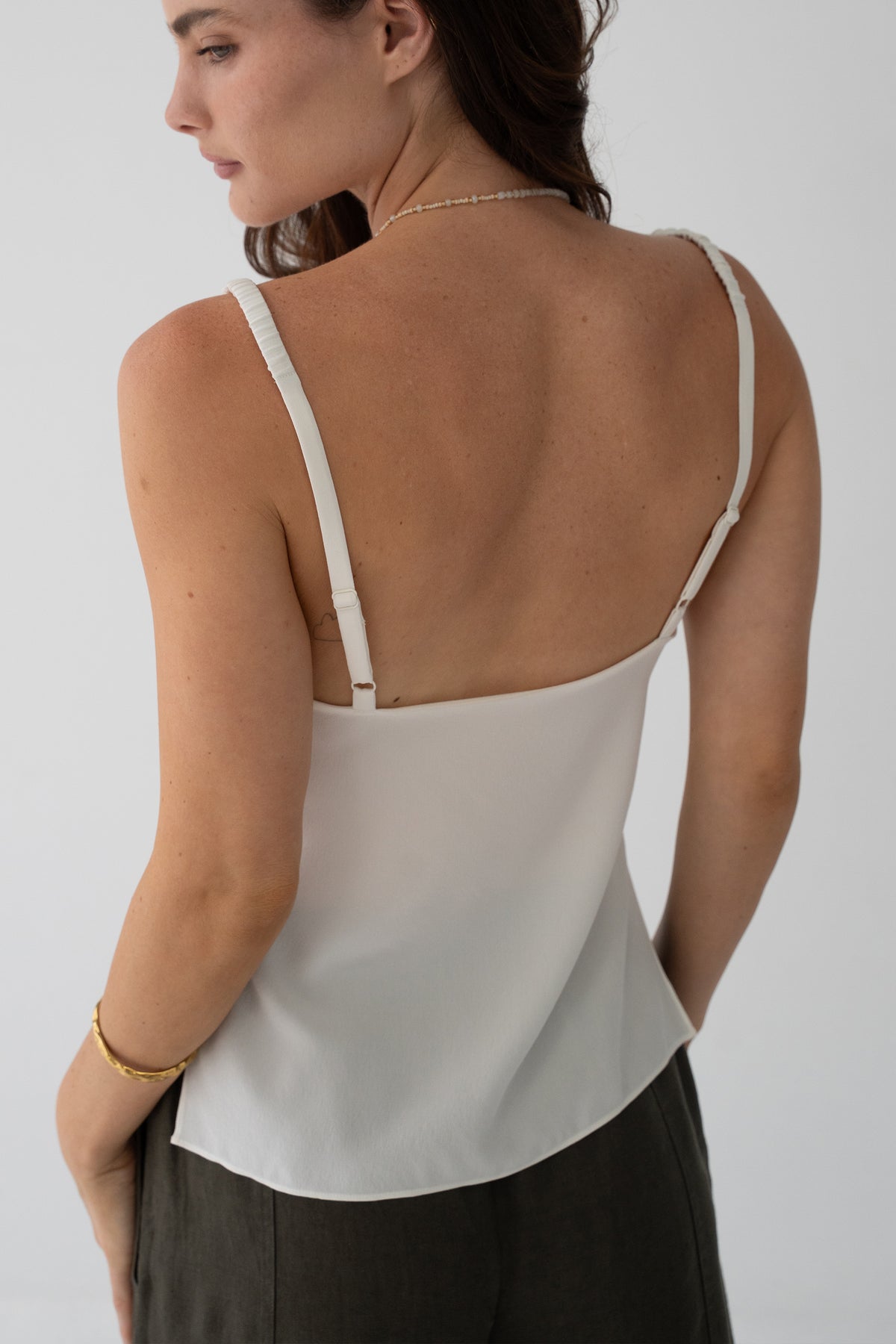 Leni Silk Cami in Ivory - back view, open back and adjustable straps, gold bracelet - Lilly Pilly Collection