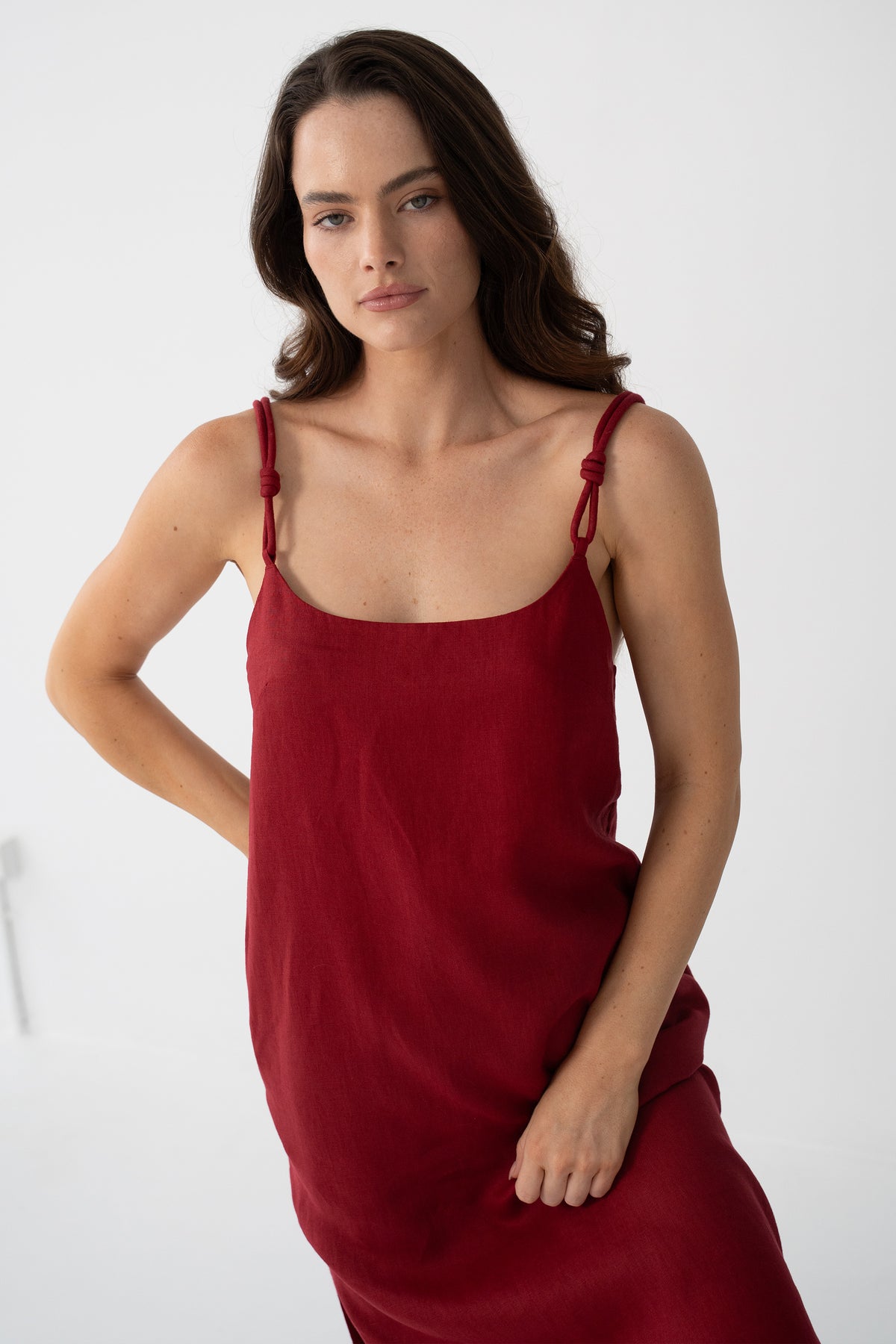 Lia Linen Midi Slip Dress in Cherry Red - close-up of knotted strap and scoop neckline detail - Lilly Pilly Collection
