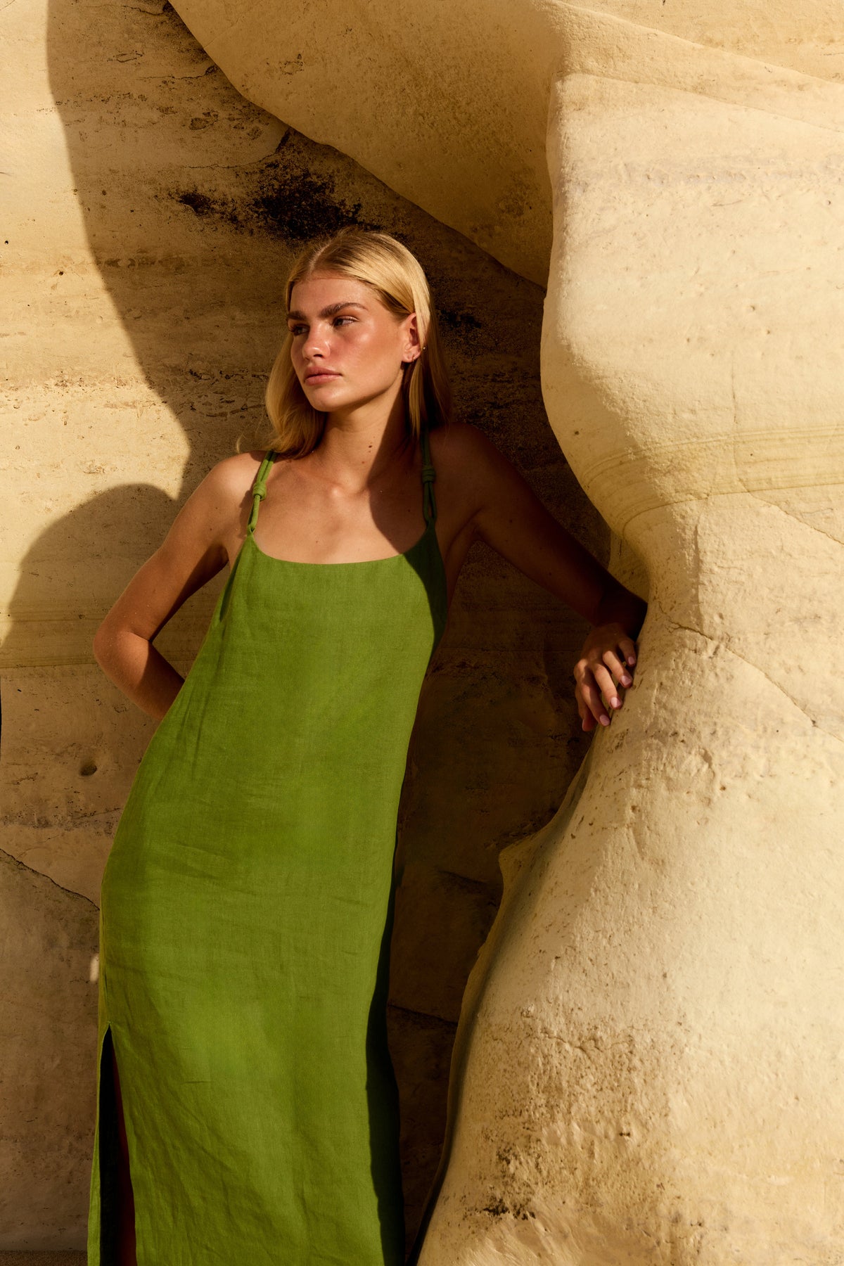 Lia Linen Midi Slip Dress in Lime Green - woman against sandstone rocks, scoop neckline and braided straps - Lilly Pilly Collection