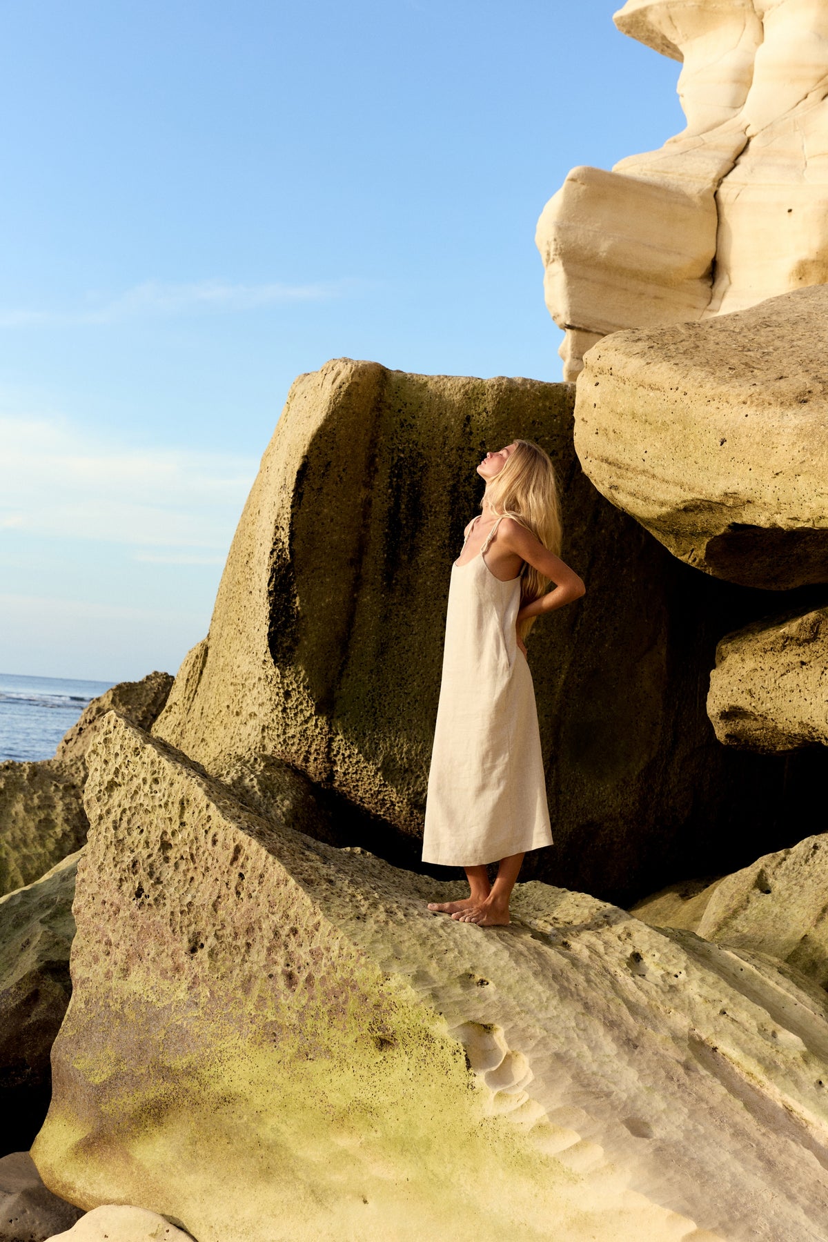 Lia Linen Midi Slip Dress in Oatmeal - woman outdoors, braided straps and fluid midi length - Lilly Pilly Collection