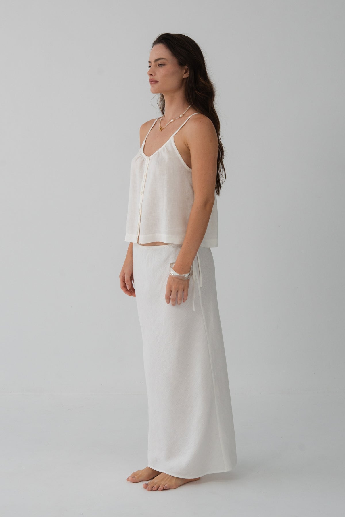 Lola Linen Cami in Ivory - side profile, gathered scoop neckline and button-front, styled with matching Riley Linen Maxi Skirt - Lilly Pilly Collection