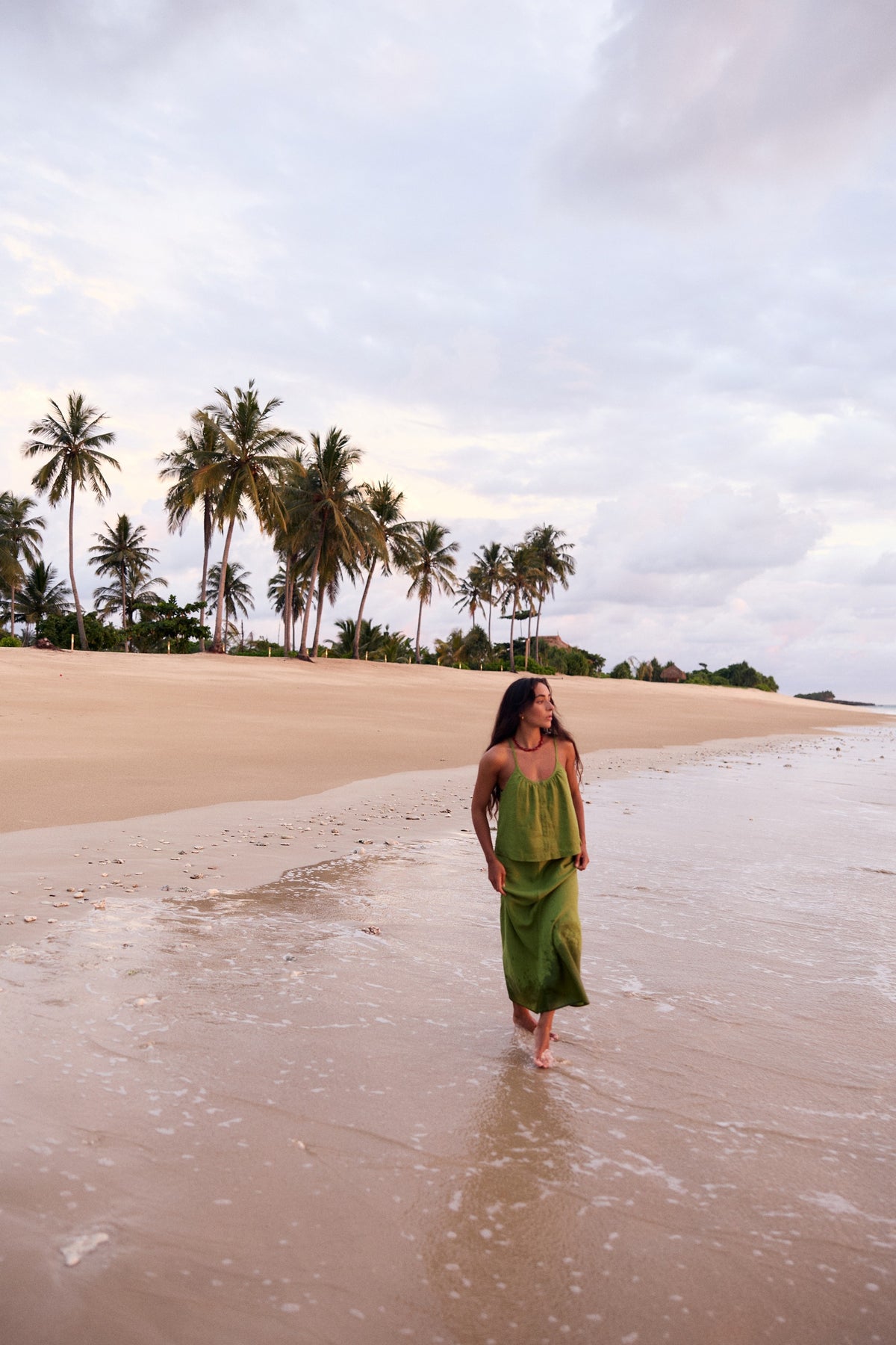 Lola Linen Cami in Lime Green - full length, walking on beach, styled with matching Riley Linen Maxi Skirt, palm tree backdrop - Lilly Pilly Collection