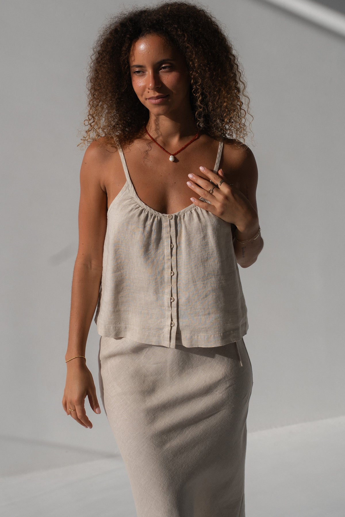 Lola Linen Cami in Oatmeal - three-quarter view, gathered scoop neckline and button-front, styled with Riley Bias Linen Midi Skirt in Oatmeal - Lilly Pilly Collection