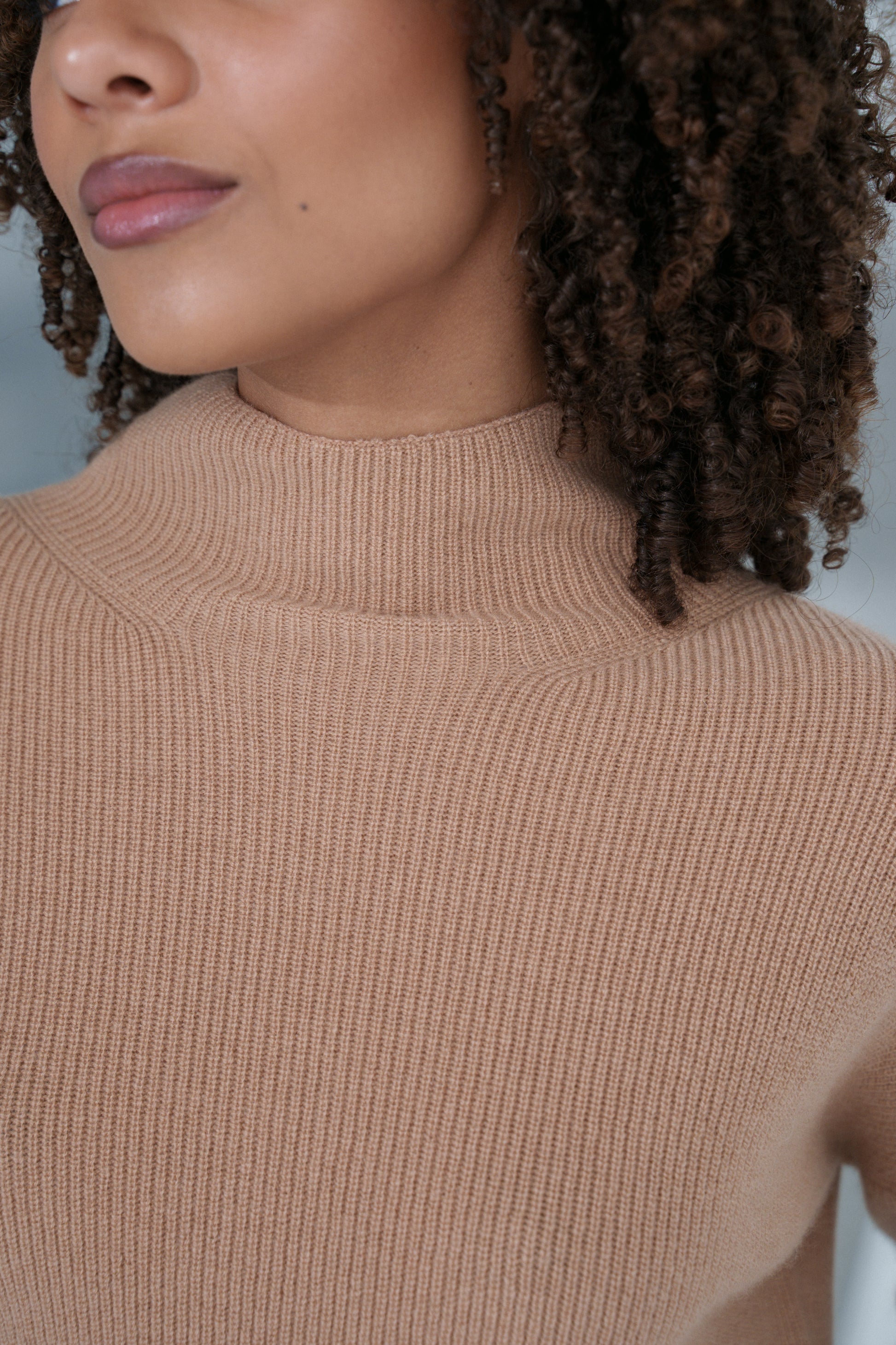 Close up of LILLY PILLY woman wearing a camel brown June cashmere knit sweater 