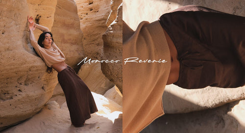 Lilly Pilly Morocco Reverie wearing Miri cashmere knit and Riley linen skirt standing by the rocks