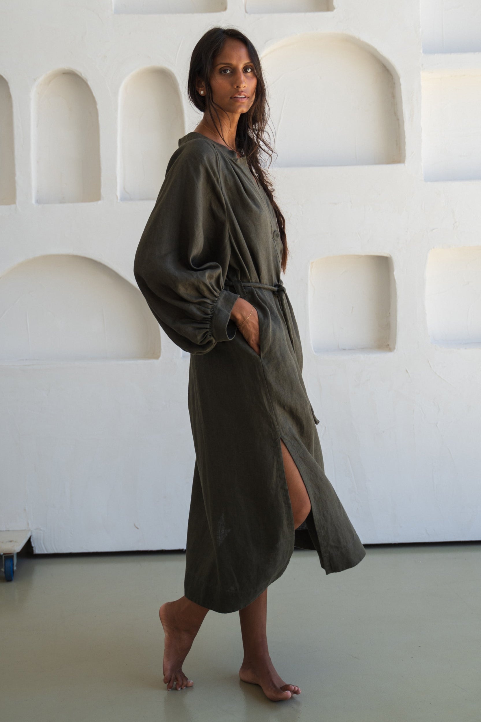 Woman wearing a khaki Mae linen dress in studio
