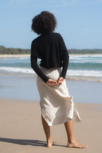 Miri Cashmere Knit in Black - back view while standing on the beach - Lilly Pilly Collection