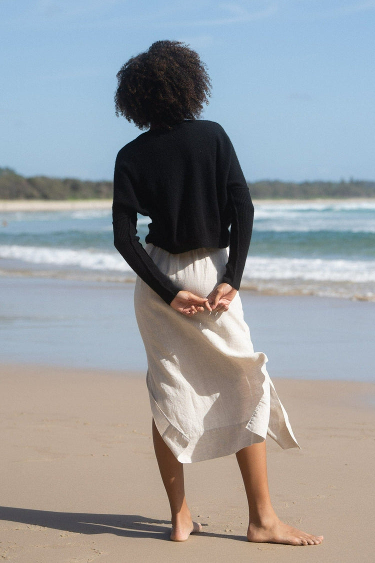 Miri Cashmere Knit in Black - back view while standing on the beach - Lilly Pilly Collection