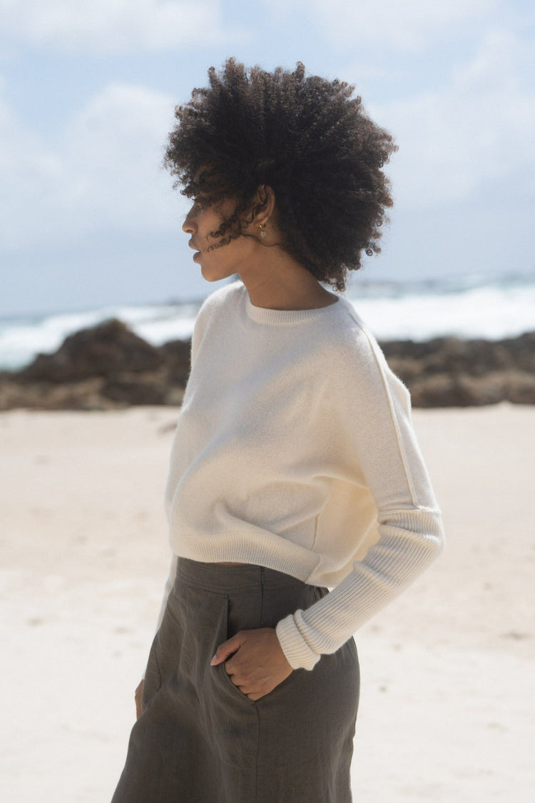 Miri Cashmere Knit in Ivory - side view while standing on the beach - Lilly Pilly Collection