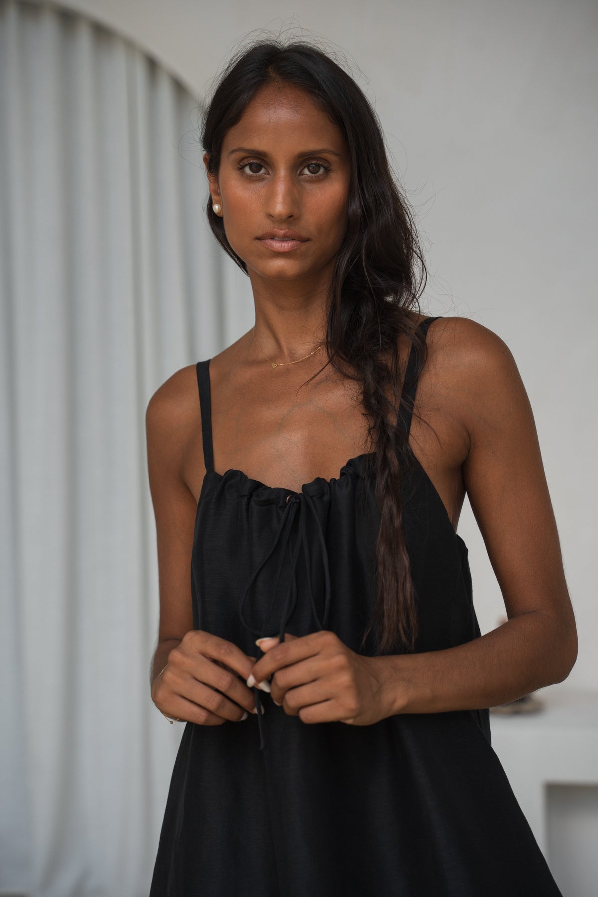 Woman wearing a black dress with a blurred background