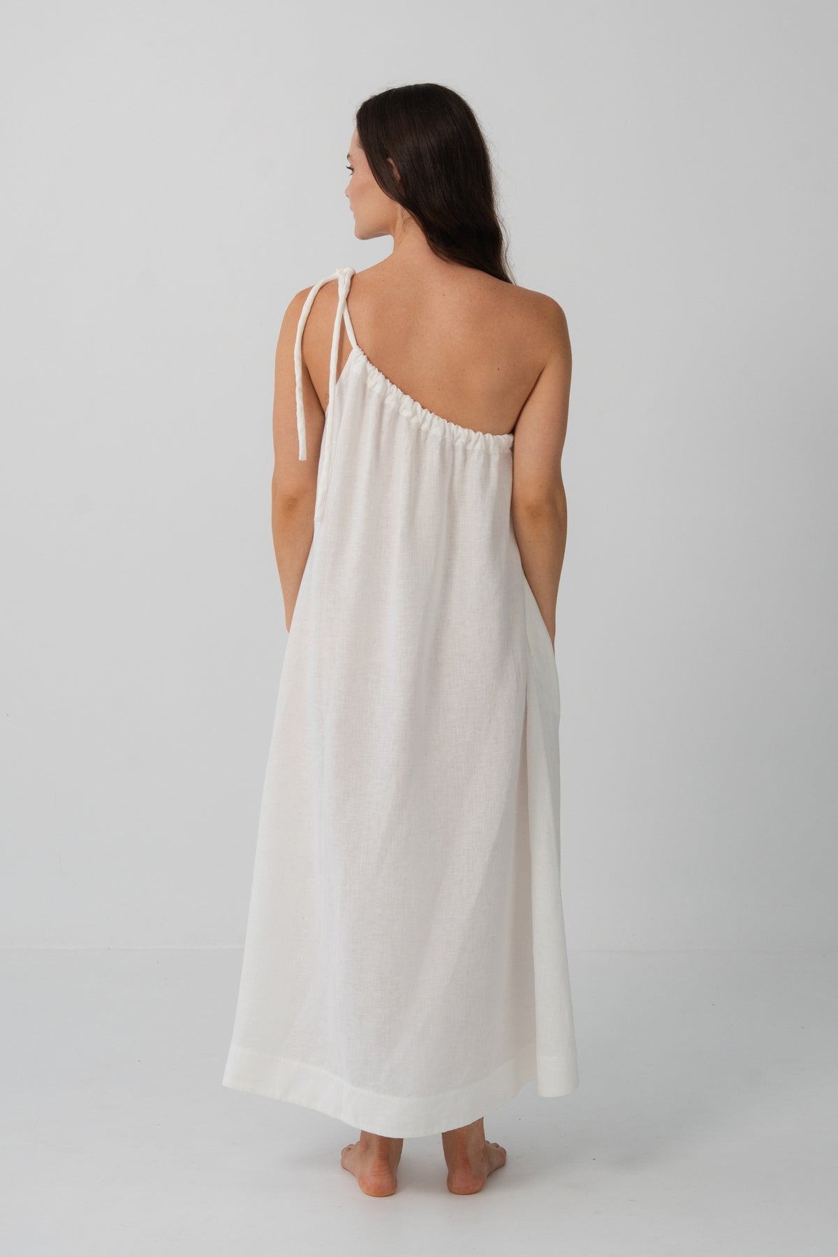 Ophelia Linen Midi Dress in Ivory - back view, open back and spaghetti straps, voluminous midi silhouette - Lilly Pilly Collection