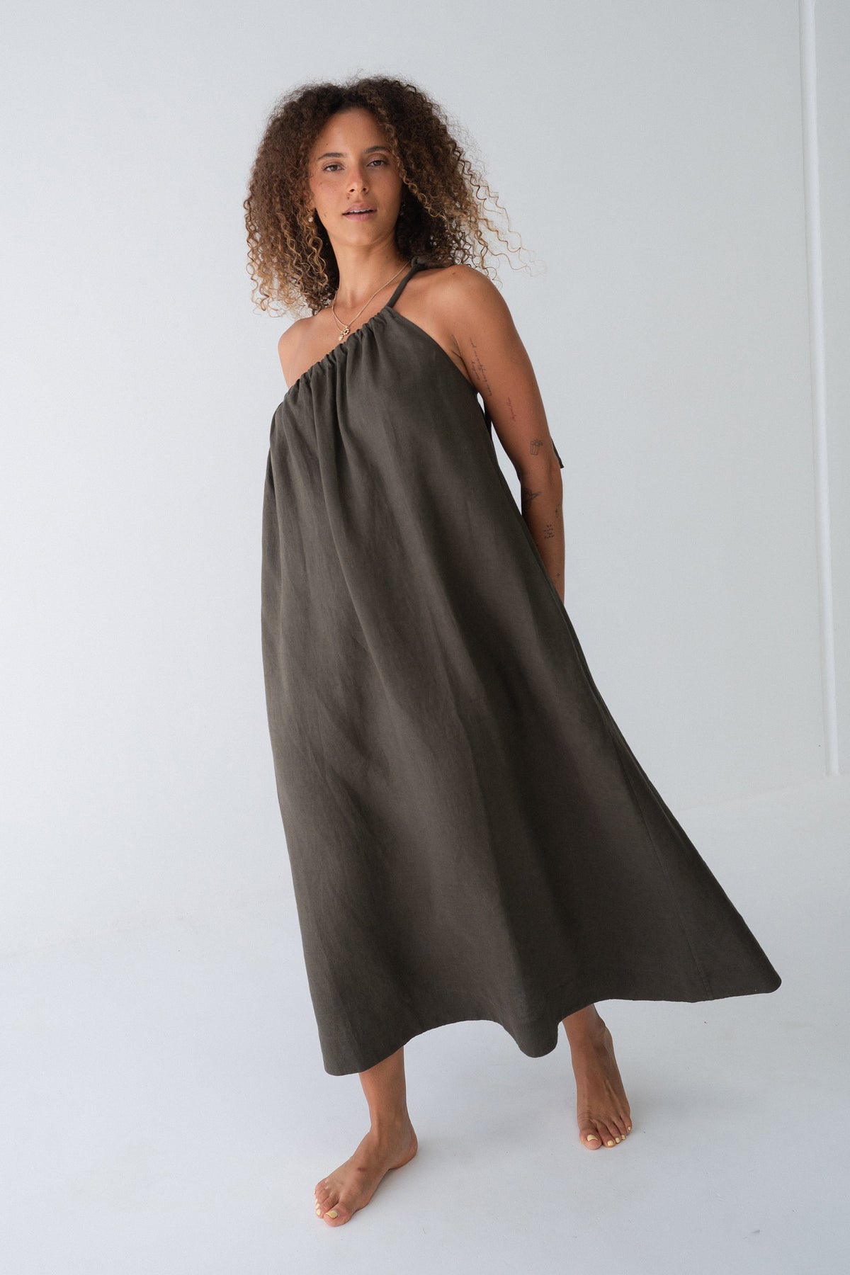Ophelia Linen Midi Dress in Khaki - full length view, asymmetric gathered neckline and voluminous midi silhouette - Lilly Pilly Collection