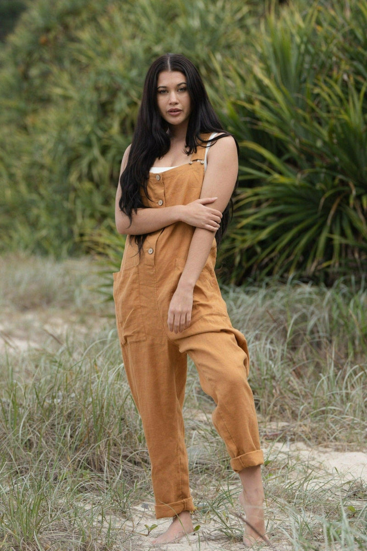 Piper Linen Jumpsuit in Nutmeg Orange - full front view standing in the grassy sand dunes - Lilly Pilly Collection