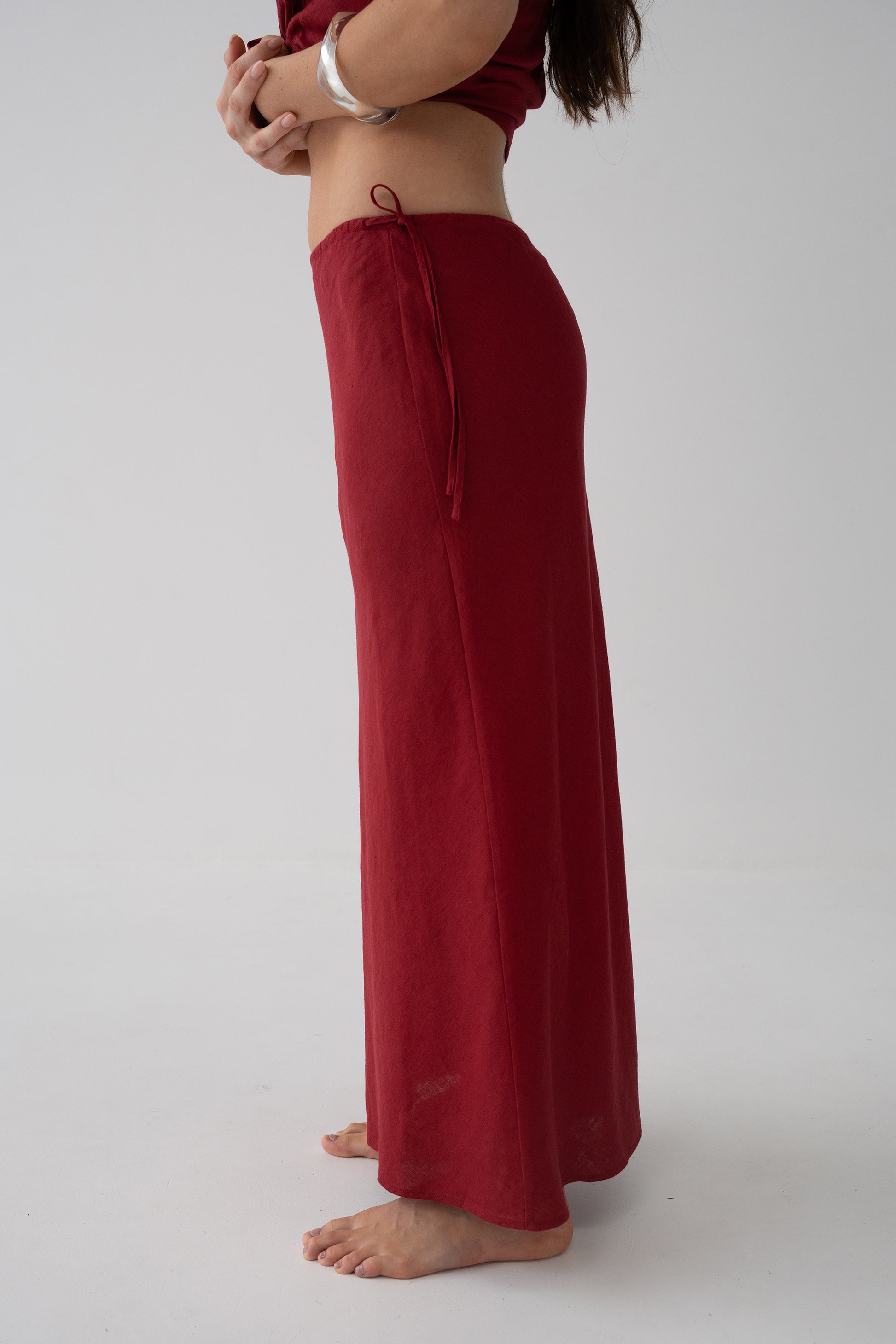 Riley Bias Linen Midi Skirt in Cherry Red - side view showing elasticated drawstring waistband and bias-cut midi length - Lilly Pilly Collection