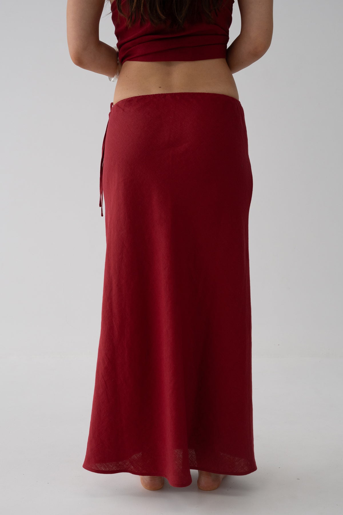 Riley Bias Linen Midi Skirt in Cherry Red - back view showing drawstring waistband and bias-cut skirt silhouette - Lilly Pilly Collection