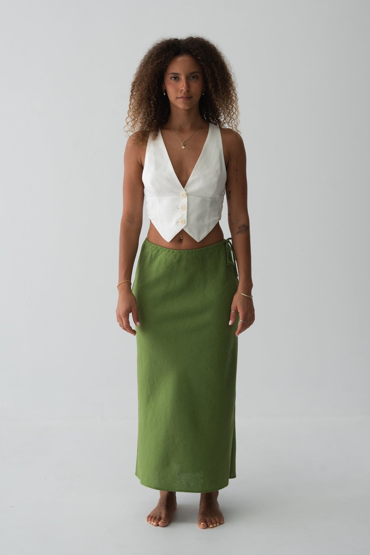 Riley Bias Linen Midi Skirt in Lime Green - full length front view, bias-cut midi length, side tie detail, worn with ivory waistcoat crop top, gold necklace - Lilly Pilly Collection