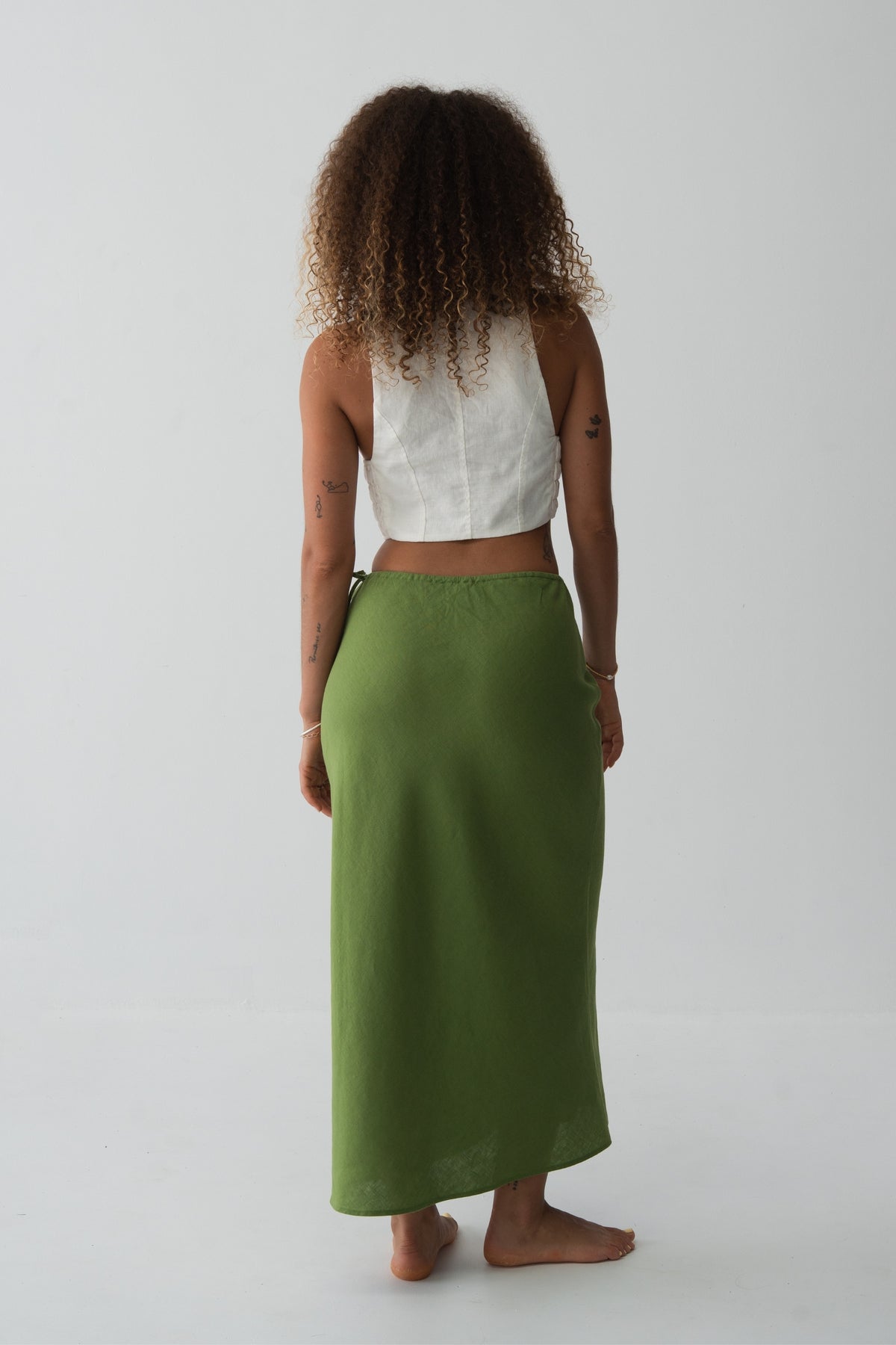 Riley Bias Linen Midi Skirt in Lime Green - back view, bias-cut midi length, side tie detail, worn with ivory waistcoat crop top - Lilly Pilly Collection