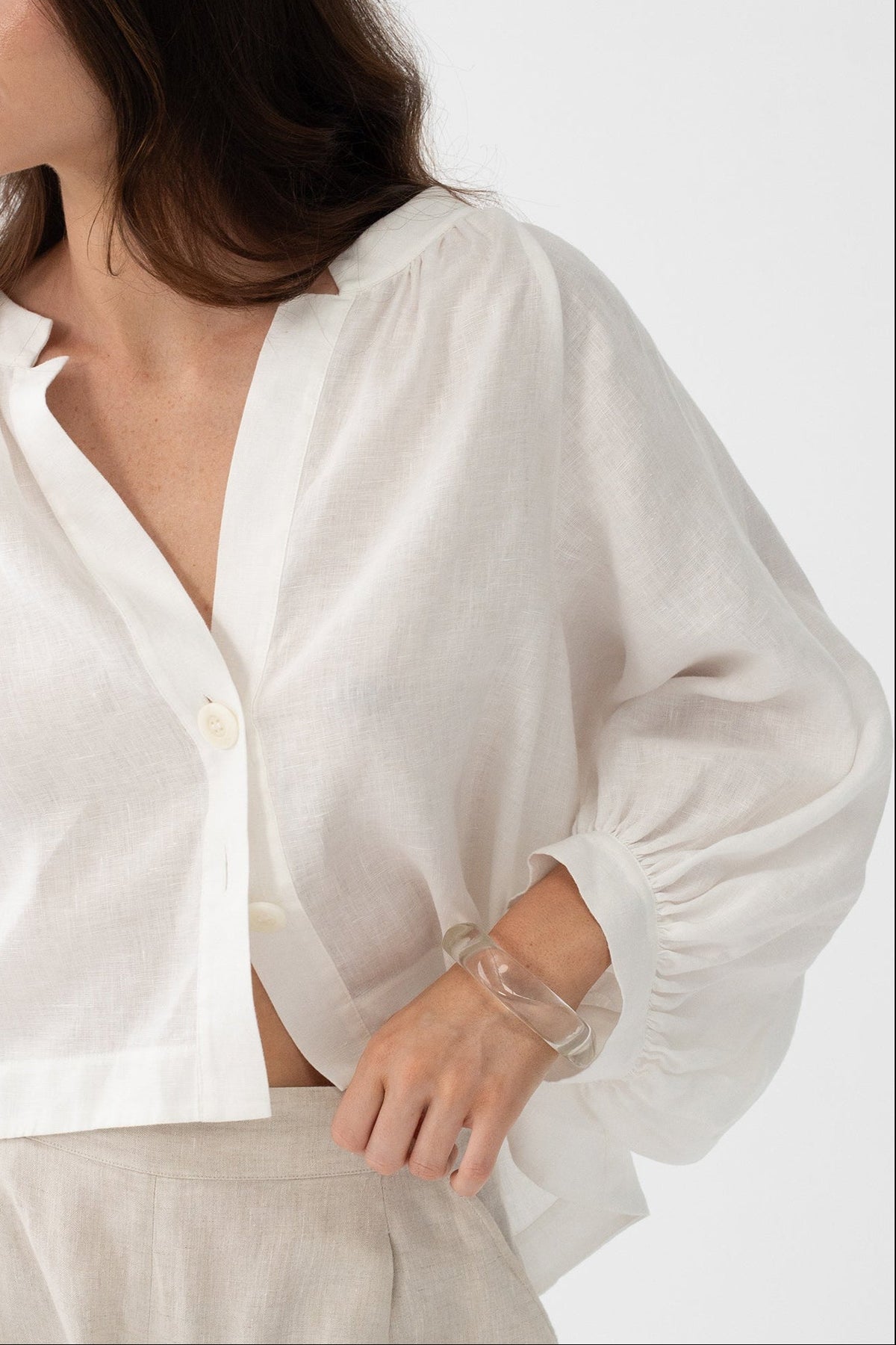 Rowan Linen Shirt in Ivory - three-quarter view, open V-neckline and button-front, styled with Gaia Linen Shorts in Oatmeal - Lilly Pilly Collection