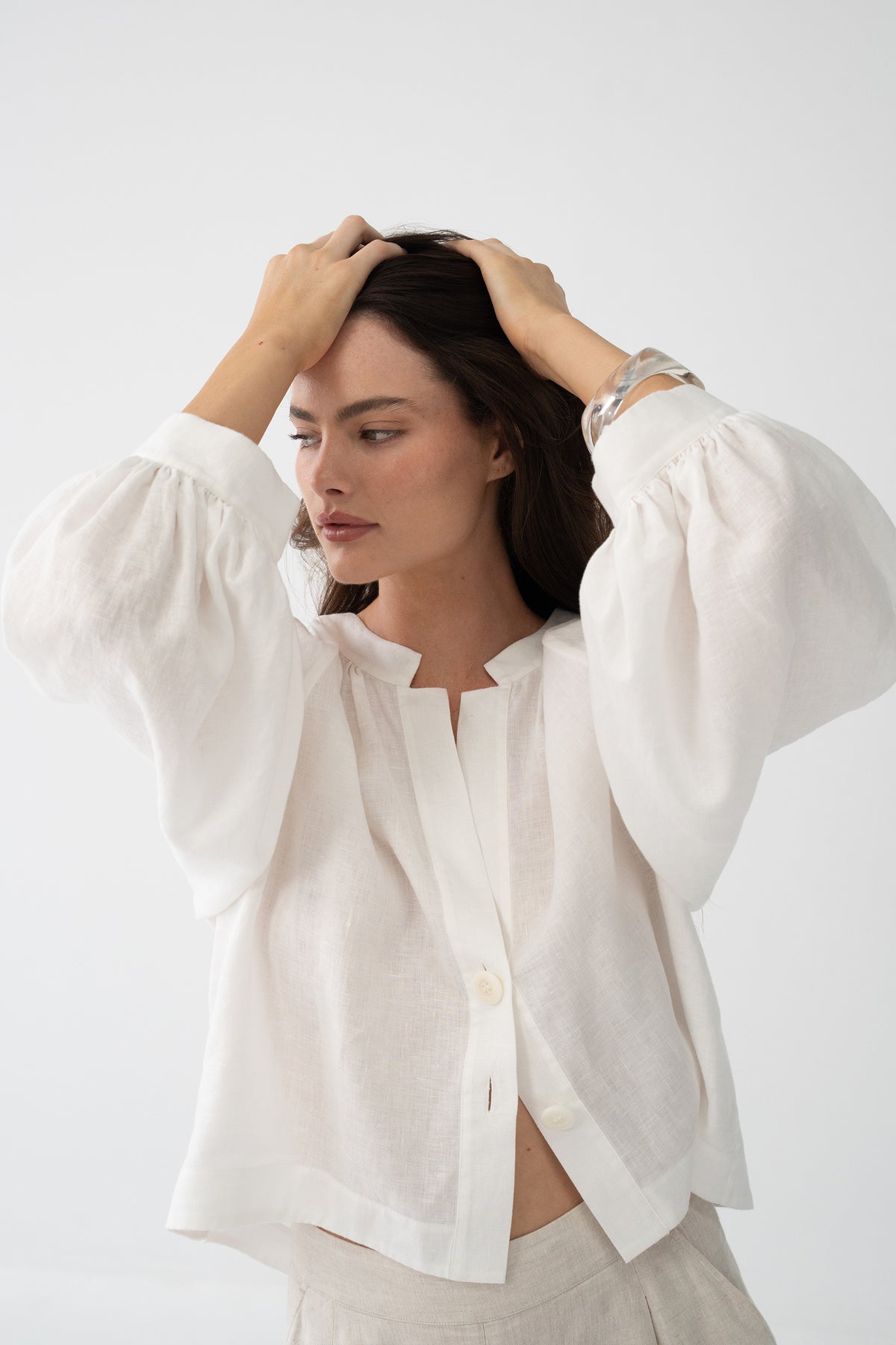 Rowan Linen Shirt in Ivory - side profile, voluminous puff sleeves, styled with Gaia Linen Shorts in Oatmeal - Lilly Pilly Collection