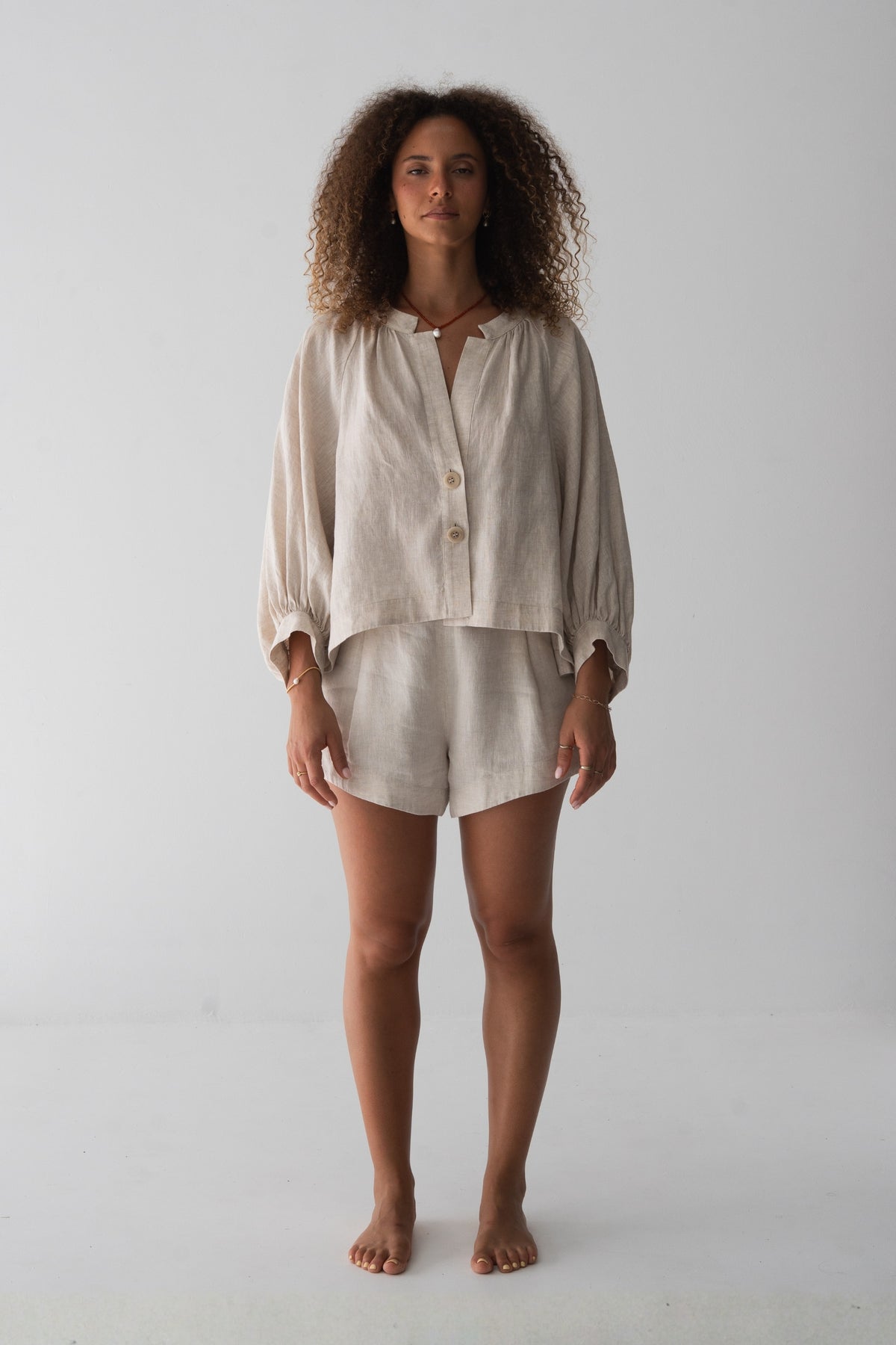 Rowan Linen Shirt in Oatmeal - full length front view, V-neckline and button-front, styled with matching Gaia Linen Shorts - Lilly Pilly Collection