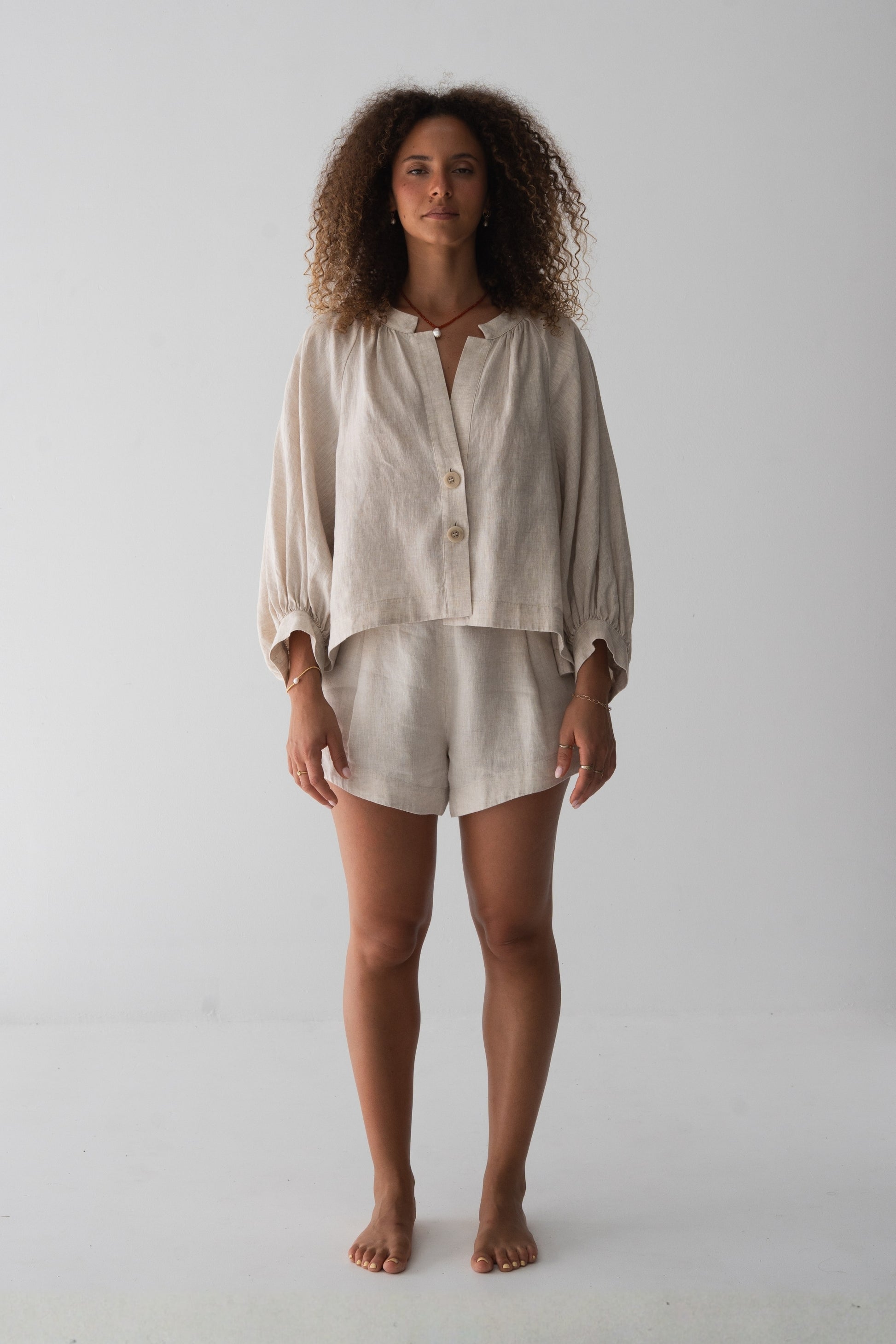 Rowan Linen Shirt in Oatmeal - full length front view, V-neckline and button-front, styled with matching Gaia Linen Shorts - Lilly Pilly Collection
