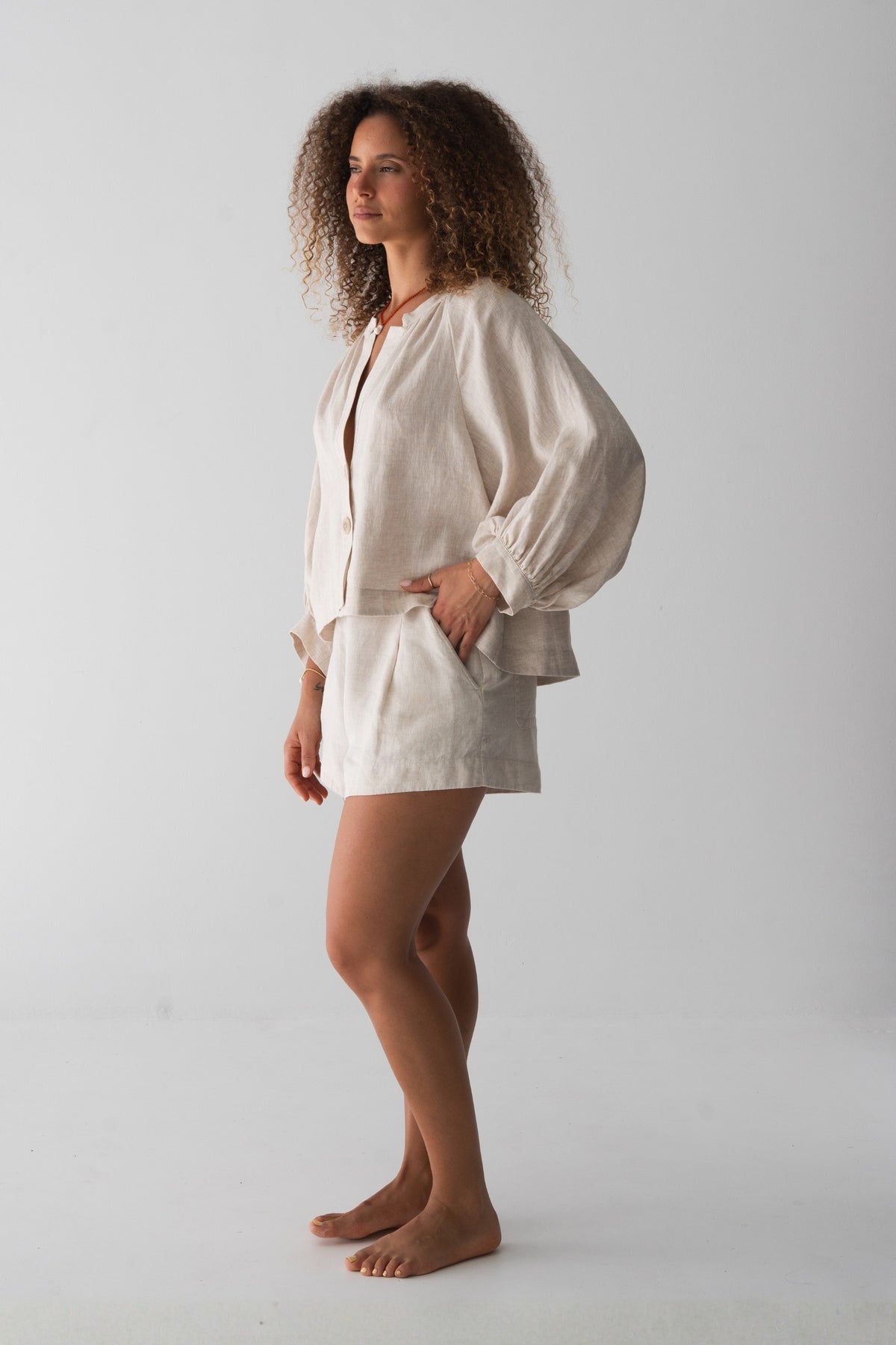 Rowan Linen Shirt in Oatmeal - side profile, puff sleeves and cropped hem, styled with matching Gaia Linen Shorts - Lilly Pilly Collection