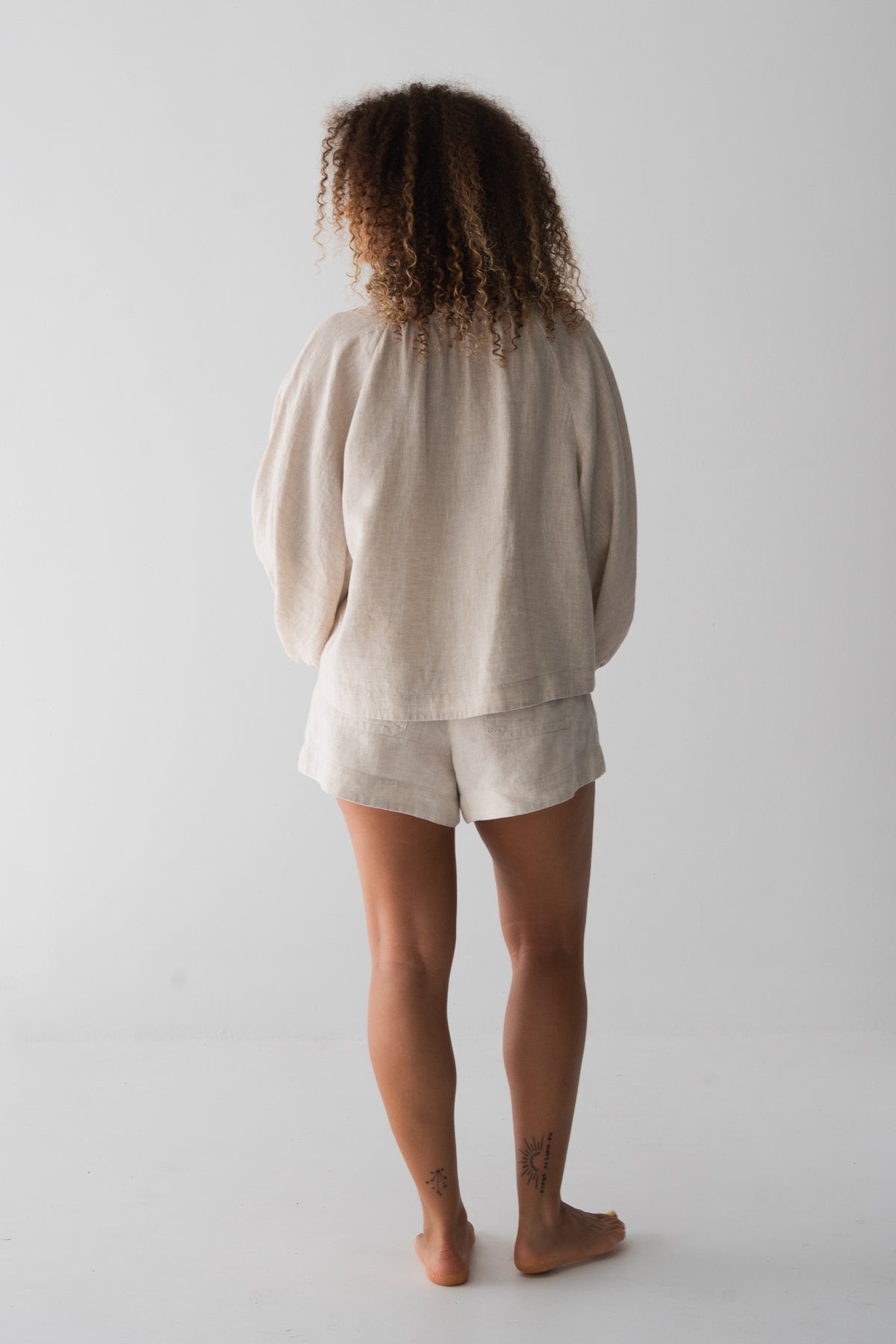 Rowan Linen Shirt in Oatmeal - back view, gathered back and puff sleeves, styled with matching Gaia Linen Shorts - Lilly Pilly Collection