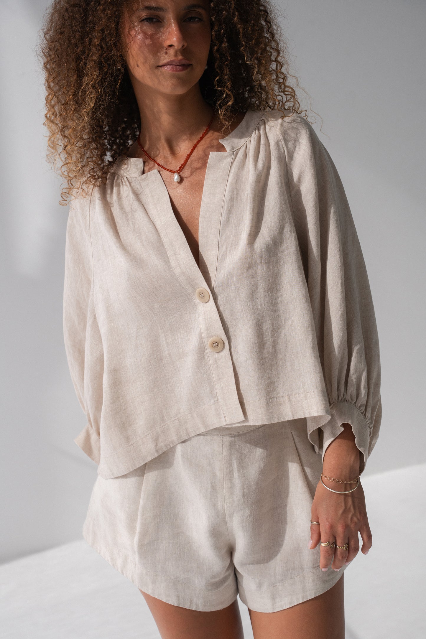 Rowan Linen Shirt in Oatmeal - close-up of V-neckline and button-front placket, styled with matching linen shorts - Lilly Pilly Collection