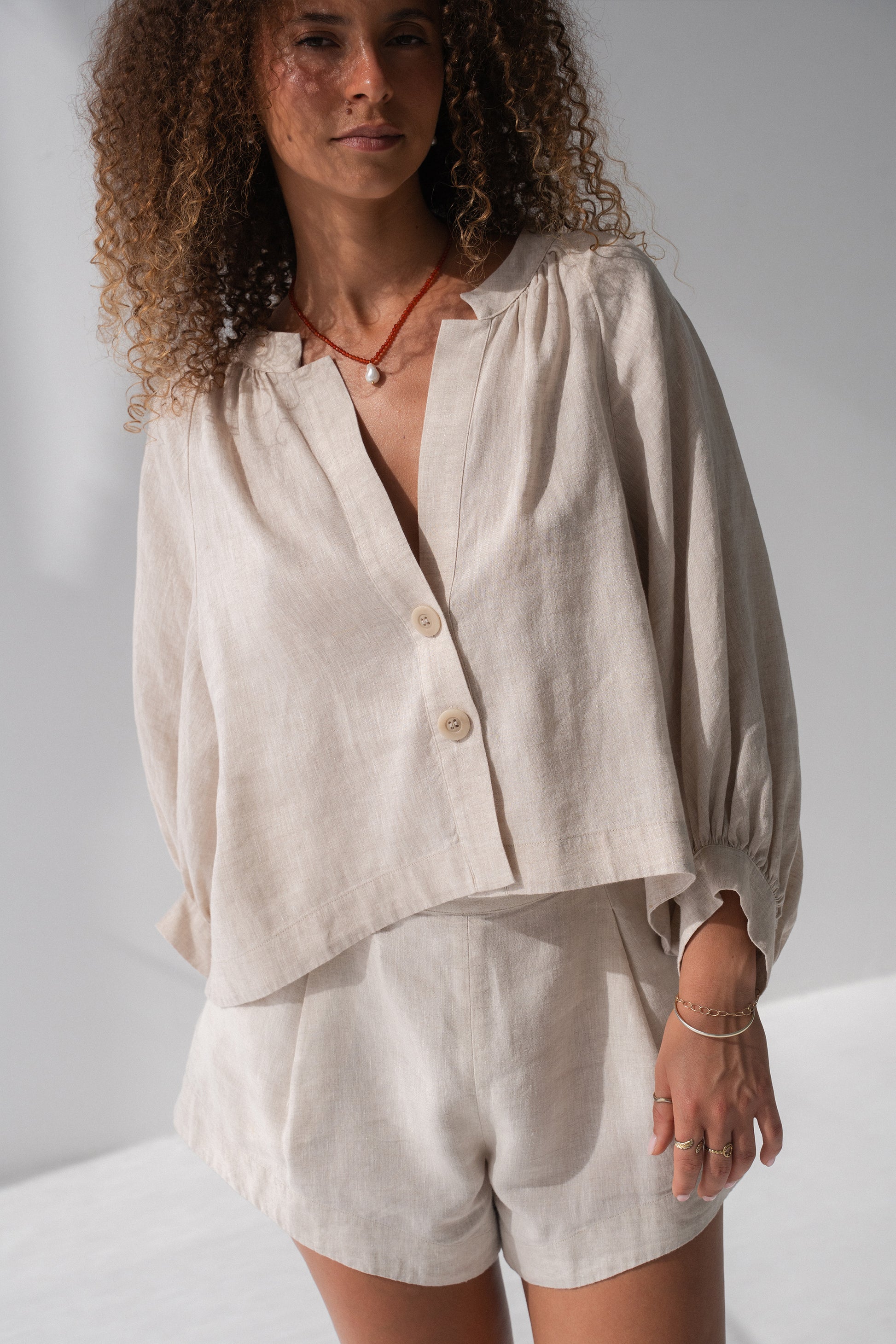 Rowan Linen Shirt in Oatmeal - close-up of V-neckline and button-front placket, styled with matching linen shorts - Lilly Pilly Collection