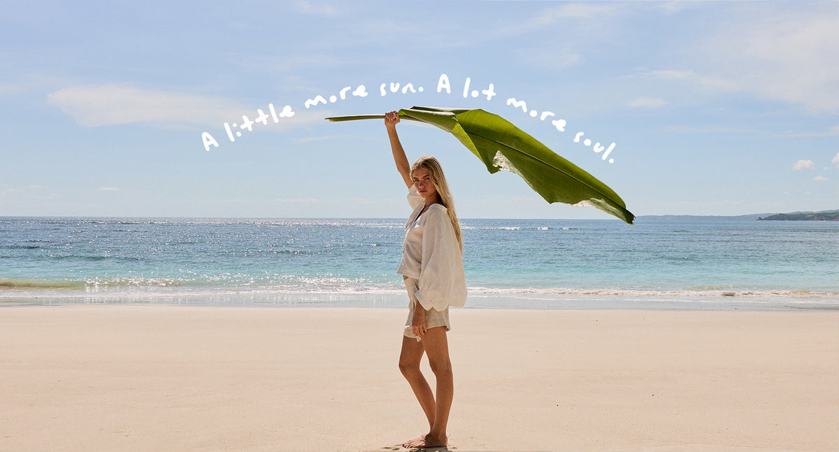 Rowan Linen Shirt in Oatmeal - side view while on the beach - Lilly Pilly Collection