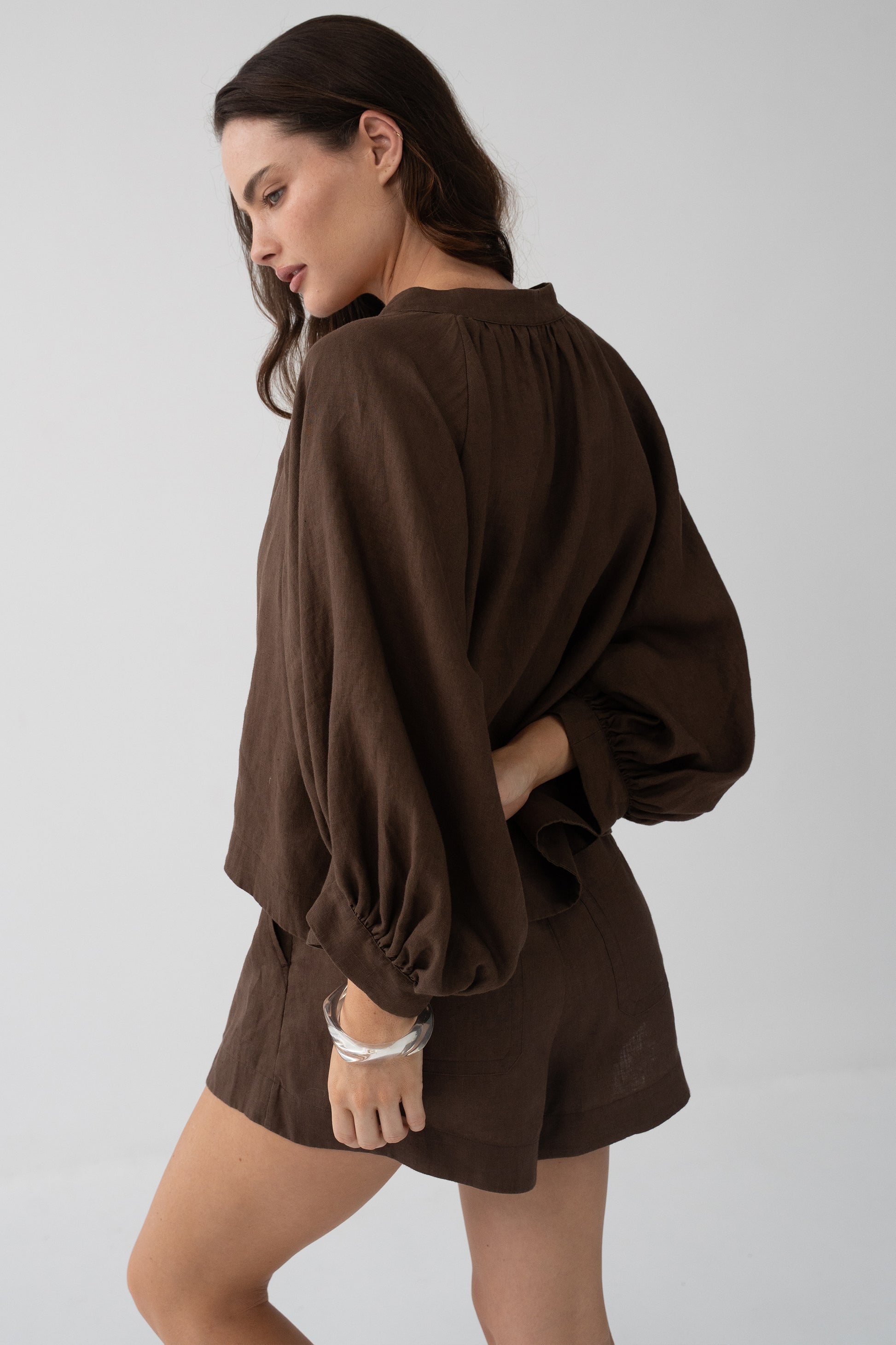Rowan Linen Shirt in Chocolate - side profile, voluminous puff sleeves with elasticated cuffs, styled with matching linen shorts - Lilly Pilly Collection