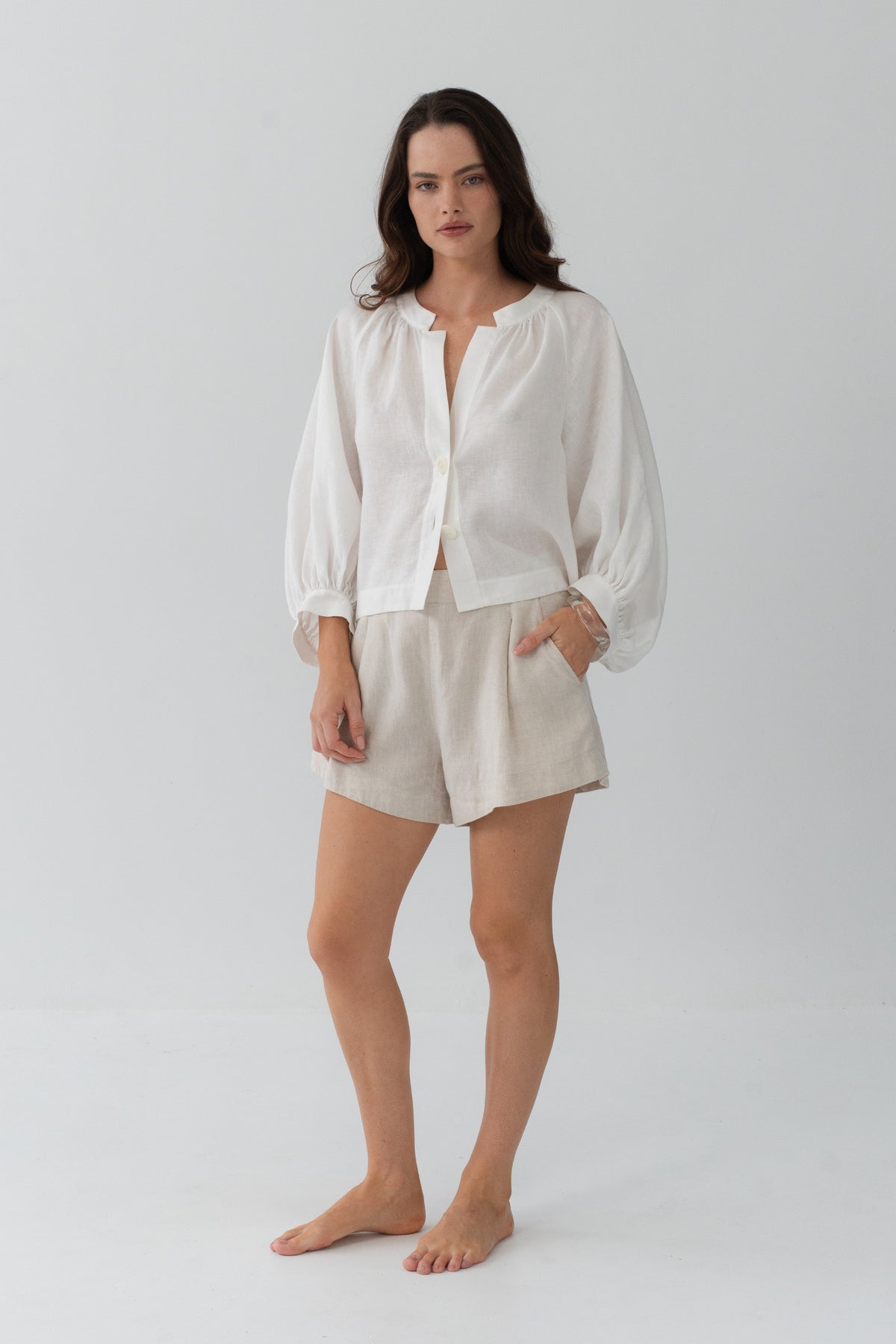 Rowan Linen Shirt in Ivory - full length front view, open V-neckline and button-front, styled with Gaia Linen Shorts in Oatmeal - Lilly Pilly Collection