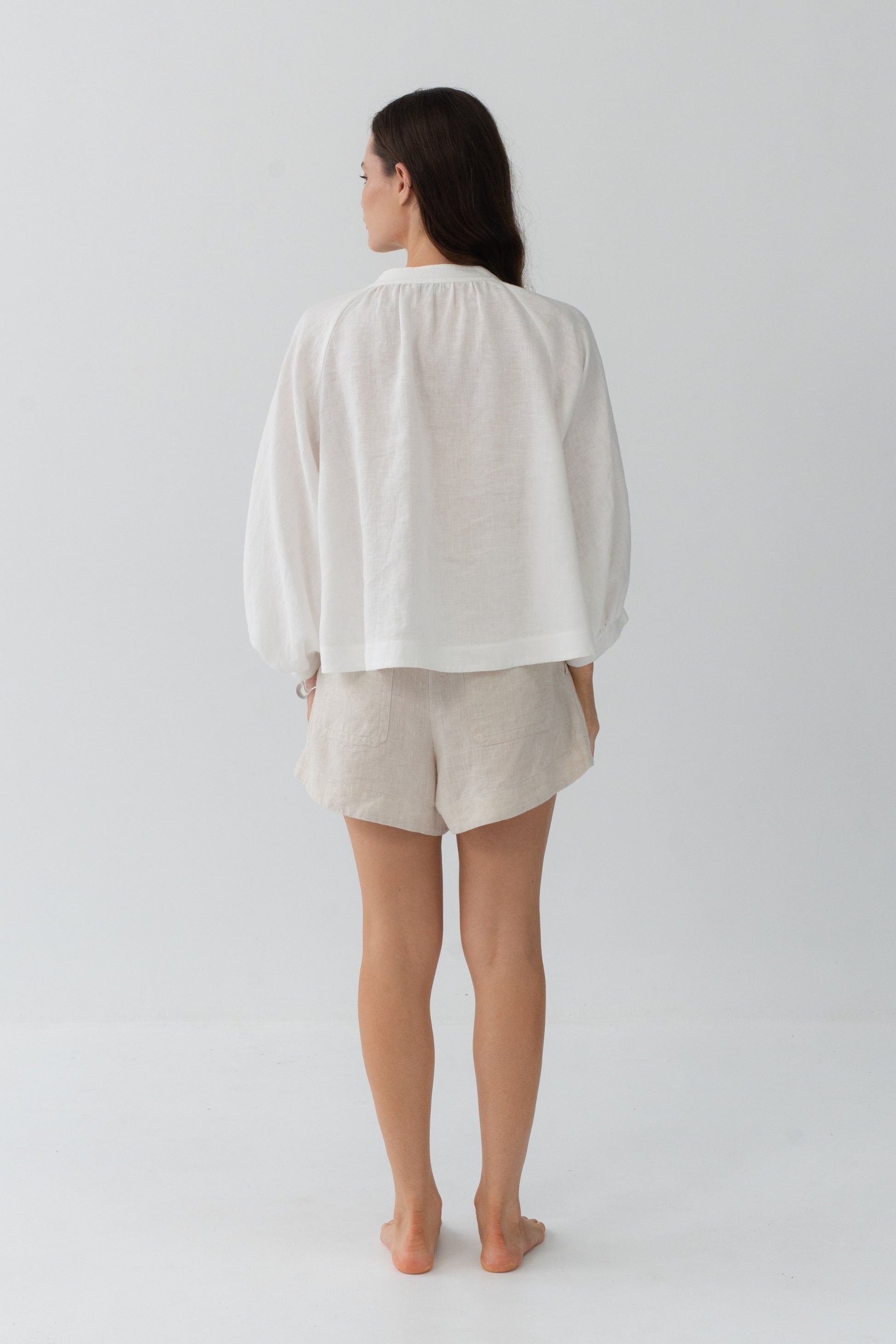 Rowan Linen Shirt in Ivory - back view, gathered back and puff sleeves, styled with Gaia Linen Shorts in Oatmeal - Lilly Pilly Collection