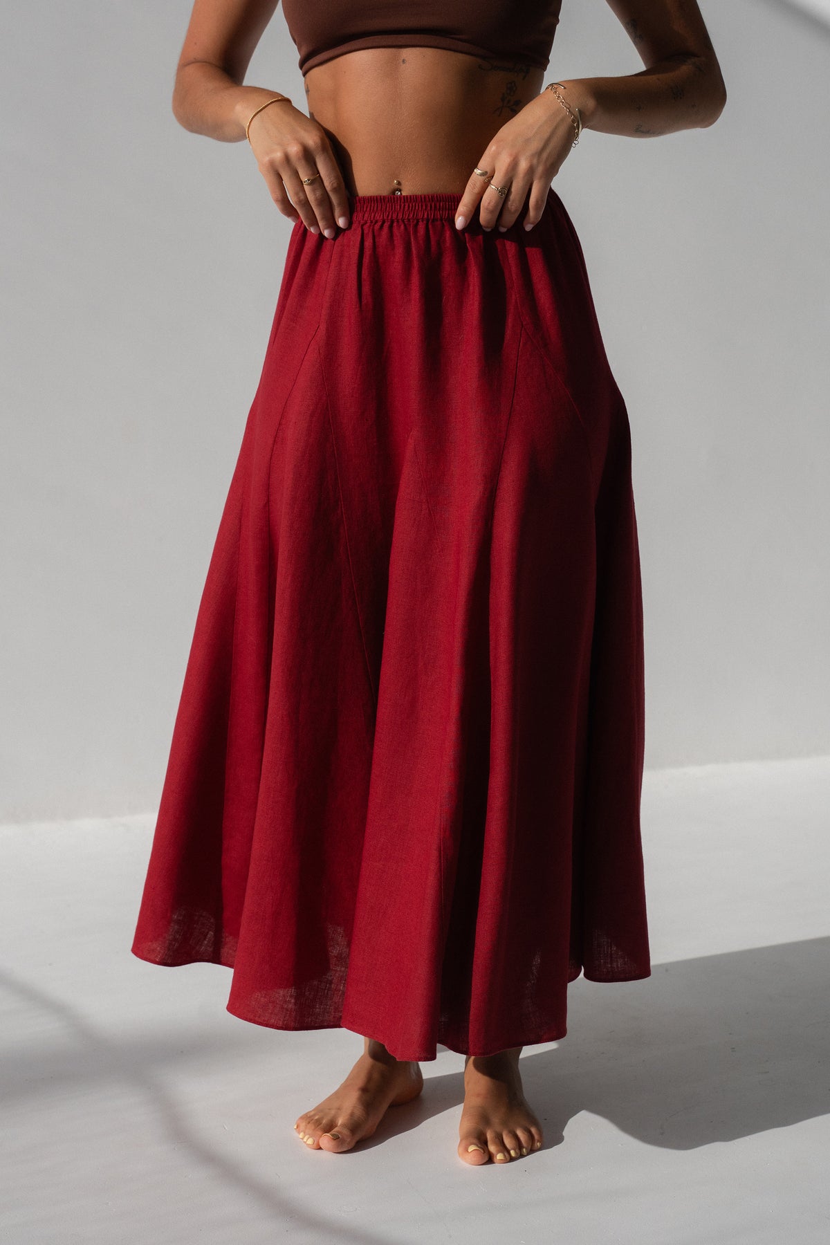 Stella Linen Maxi Skirt in Cherry Red - close-up of elasticated waistband and full A-line skirt silhouette, studio setting - Lilly Pilly Collection