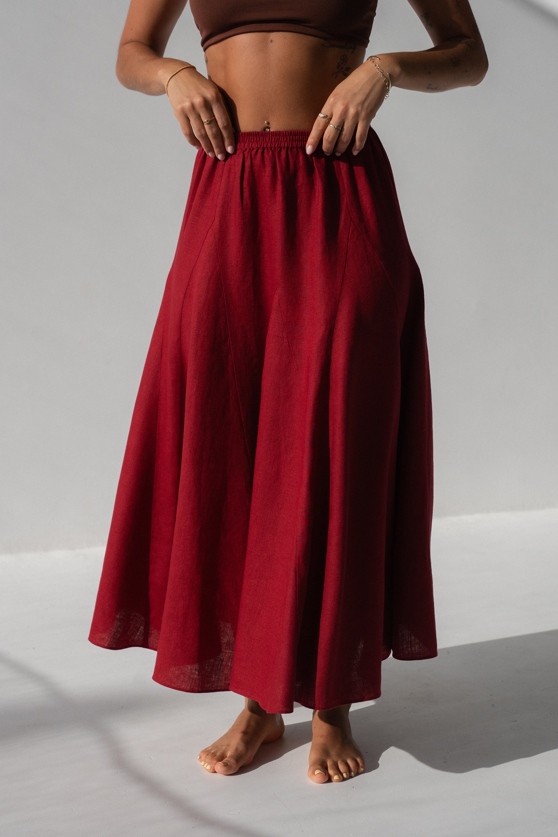 Stella Linen Maxi Skirt in Cherry Red - close-up of elasticated waistband and full A-line skirt silhouette, studio setting - Lilly Pilly Collection