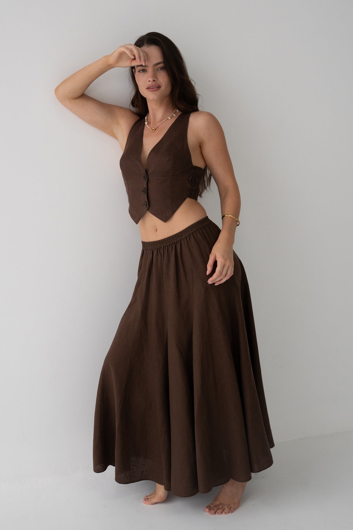 Stella Linen Maxi Skirt in Chocolate - full length front view, woman wearing matching Chocolate linen waistcoat, studio backdrop - Lilly Pilly Collection