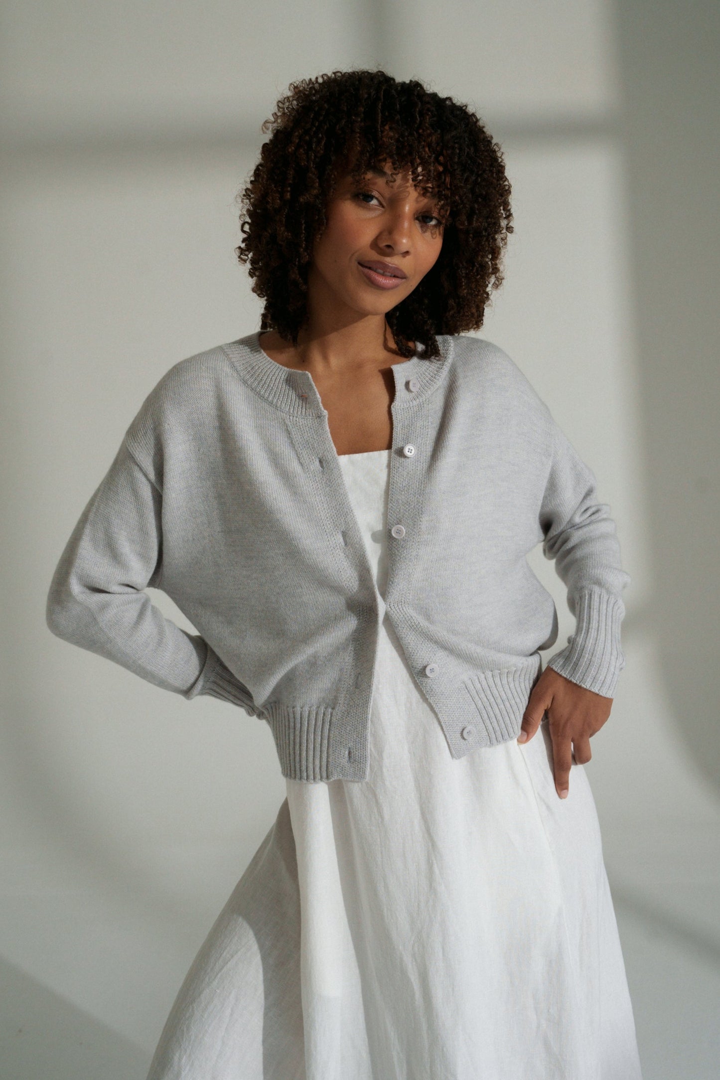 LILLY PILLY woman wearing fog coloured Taylor merino knit cardigan