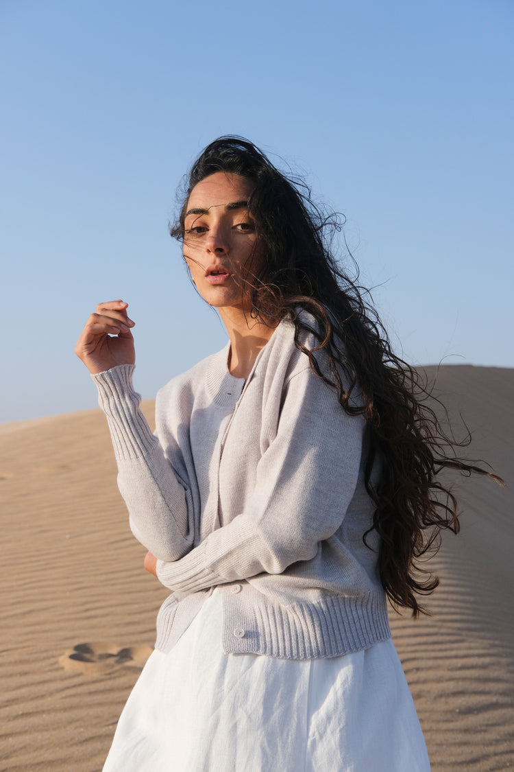 Taylor Merino Knit Cardigan in Fog Grey - front view with sand dunes in the background - Lilly Pilly Collection