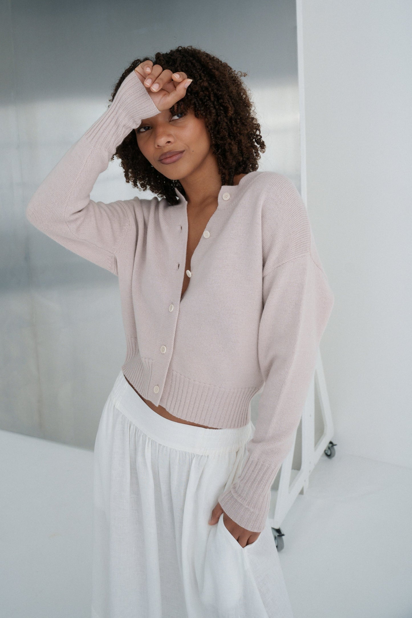LILLY PILLY Taylor merino wool knit cardi in Lilac with hand over face