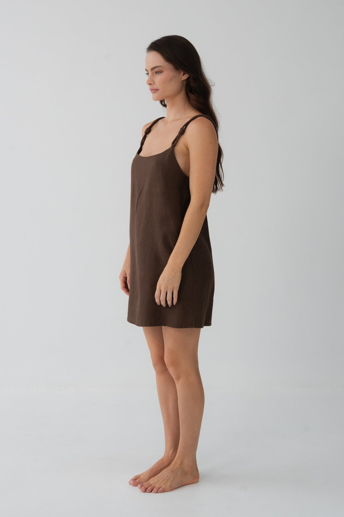 Tevi Linen Short Slip Dress in Chocolate - side profile, braided straps and short linen drape - Lilly Pilly Collection