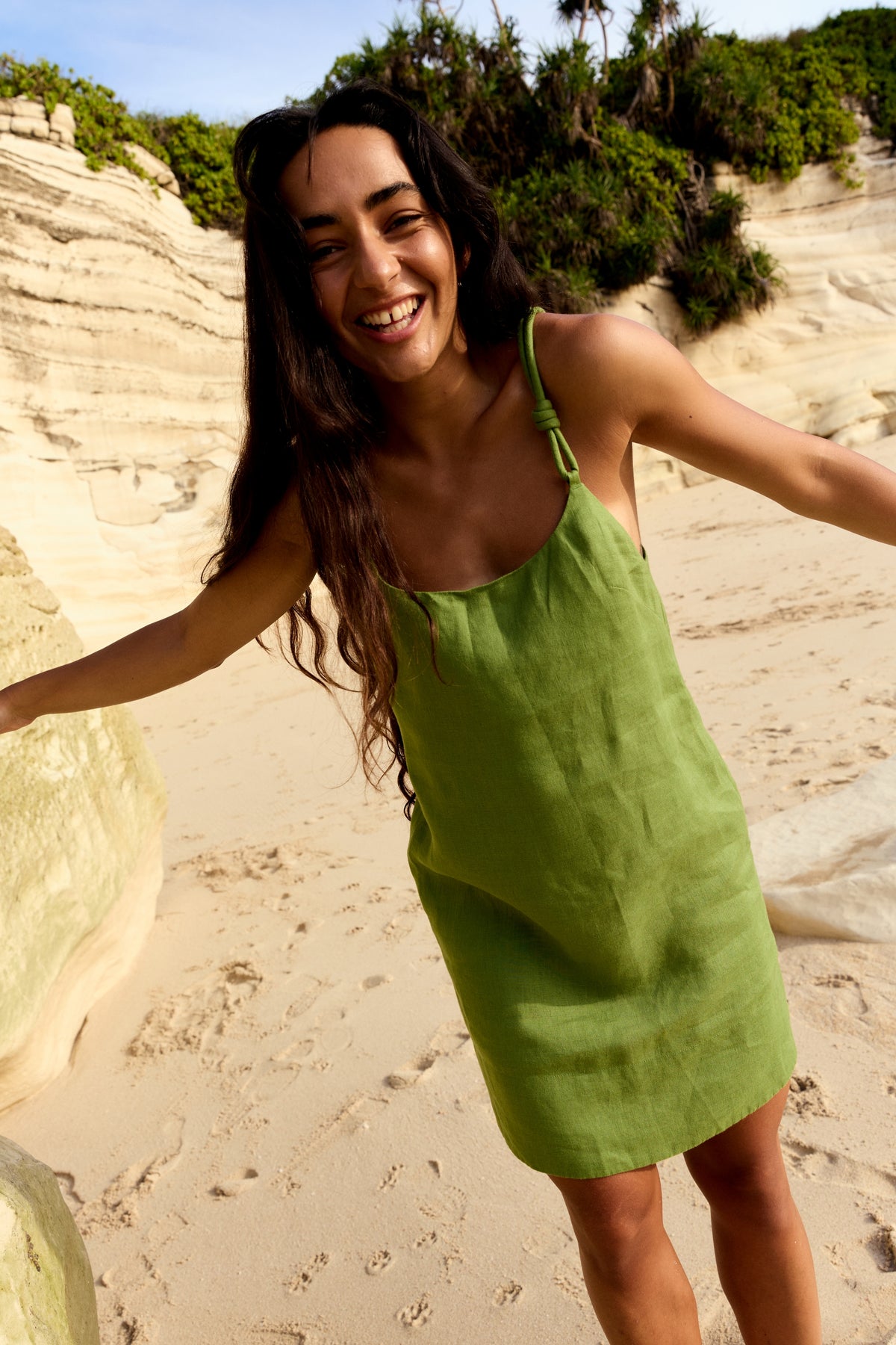Tevi Linen Short Slip Dress in Lime Green - woman in outdoor setting, scoop neckline and braided straps - Lilly Pilly Collection
